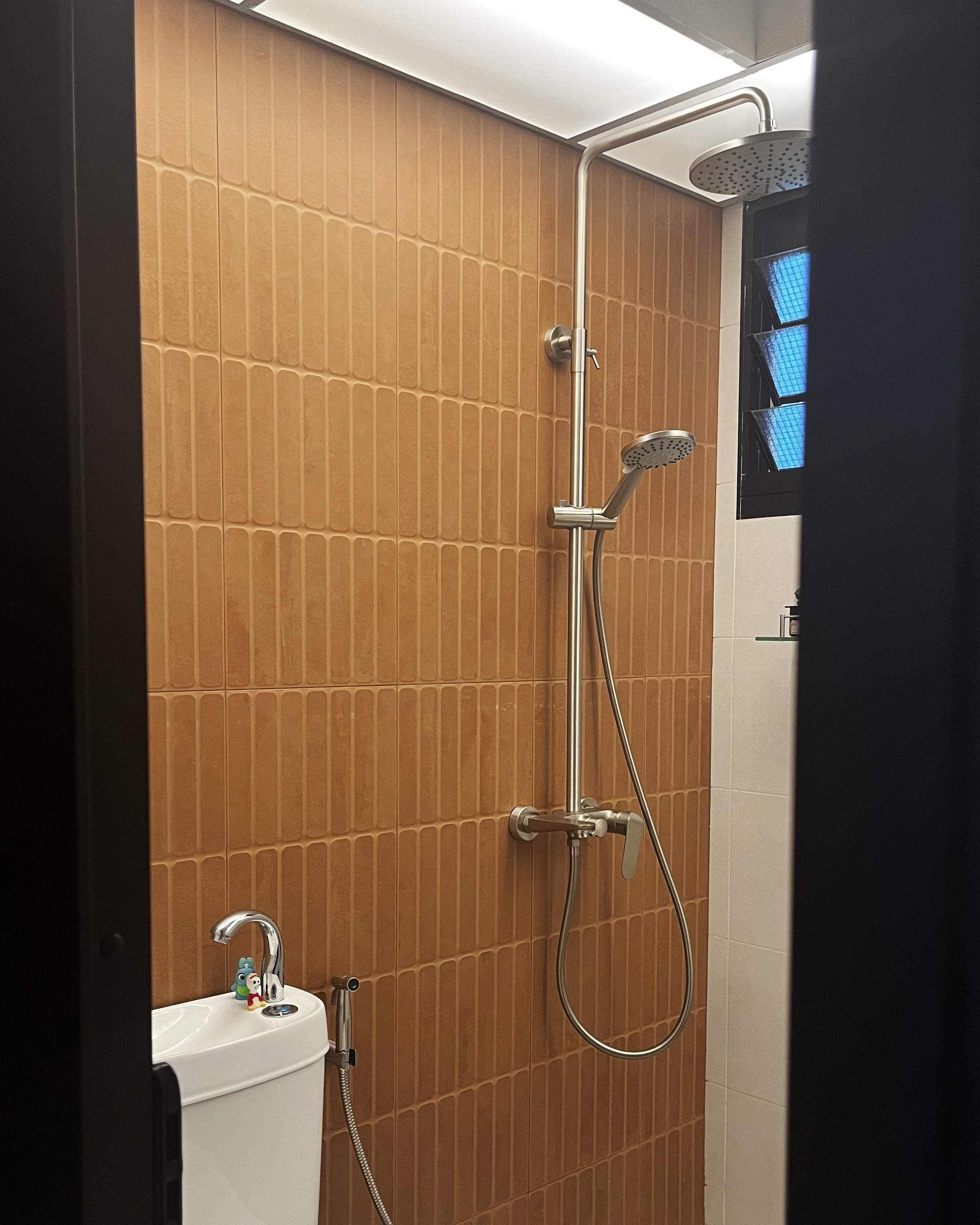 Into the room of the porcelain throne🚽🧻 - Brown tiled wall, modern shower fixtures, metallic fixtures, white toilet, small