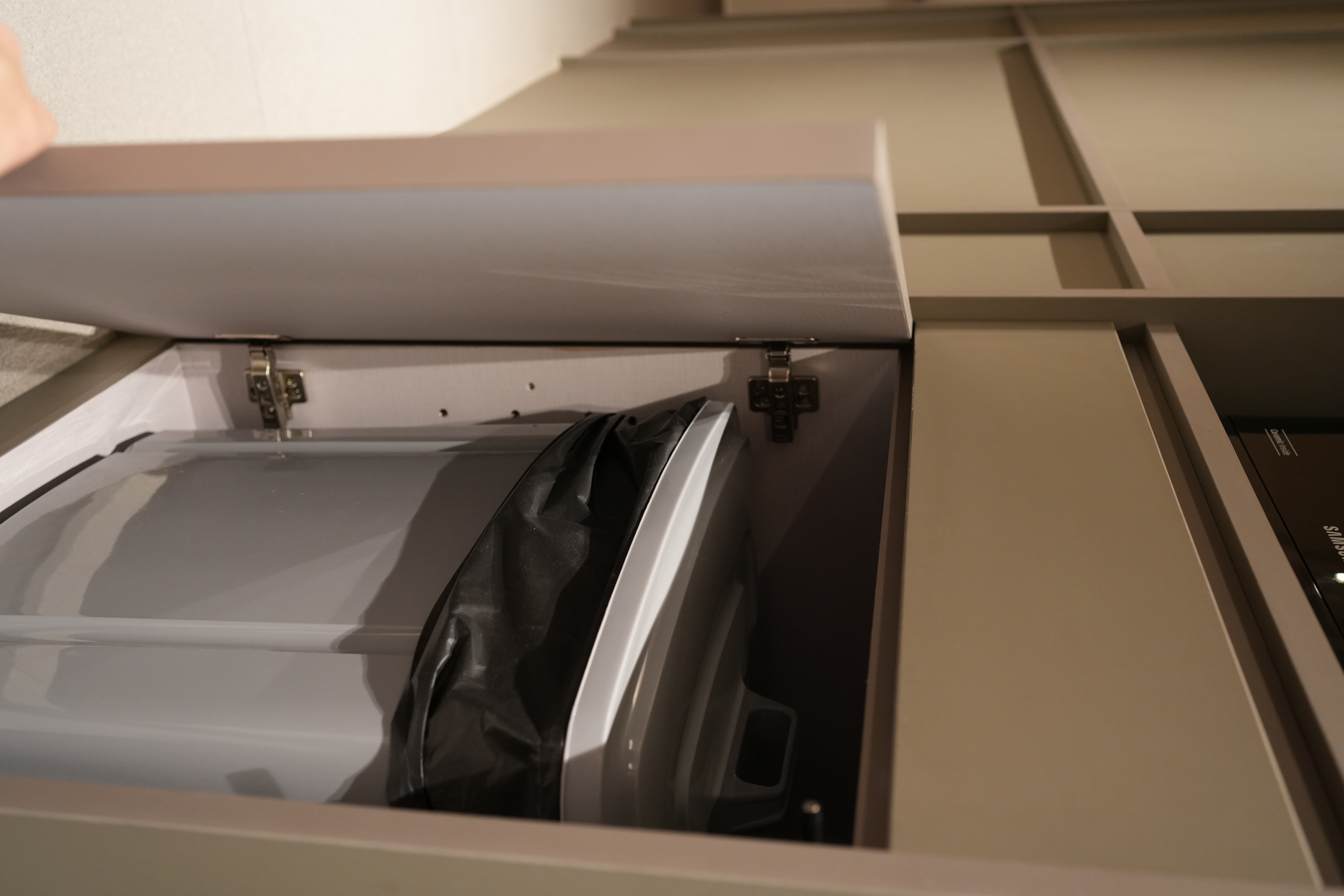 How Shinobi Houses Inspired our Modern Jap Home's Tidy, Minimal Look - Mini fridge, open drawer, laundry compartment, black