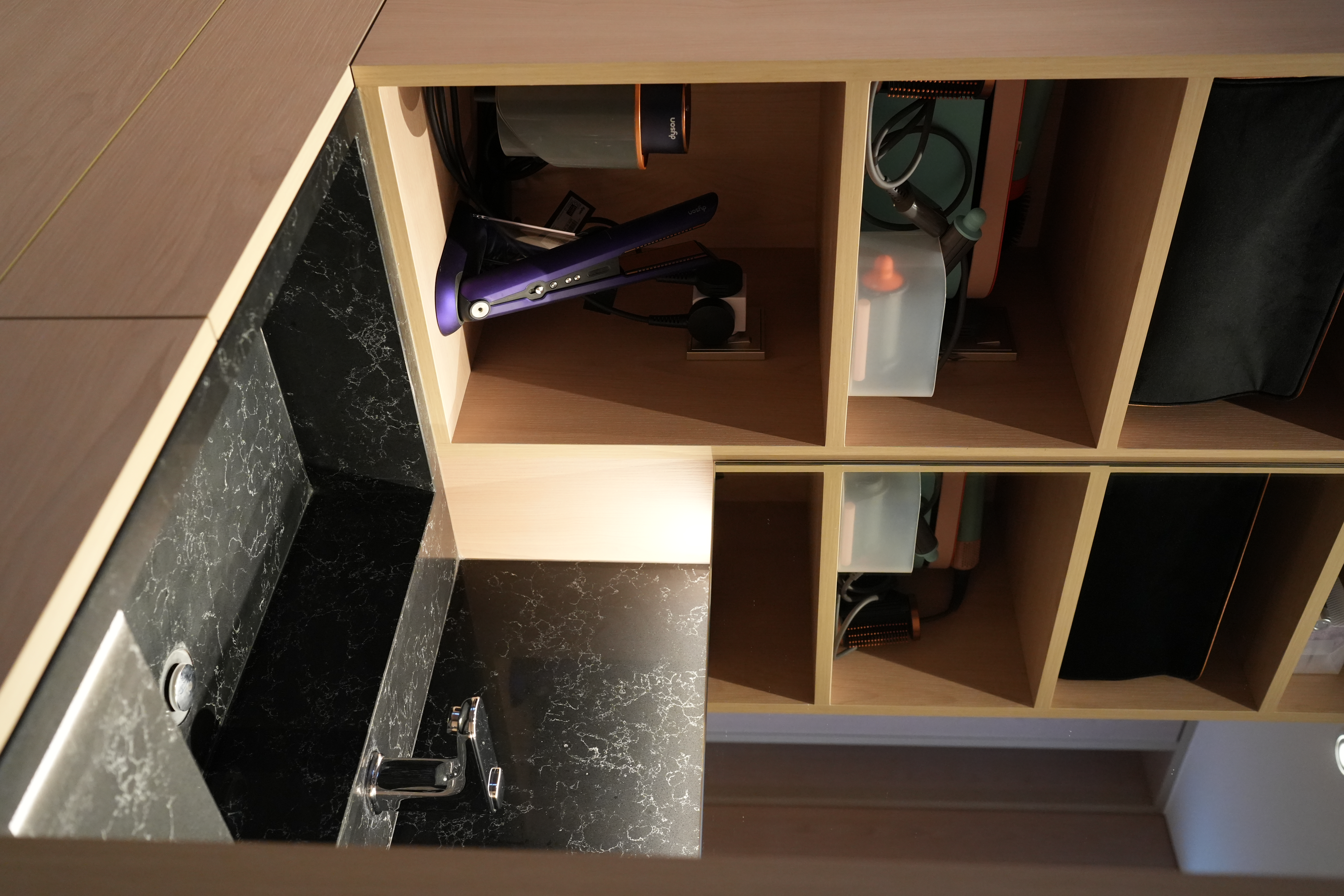 How Shinobi Houses Inspired our Modern Jap Home's Tidy, Minimal Look - Wooden cabinet with black marble countertop, black