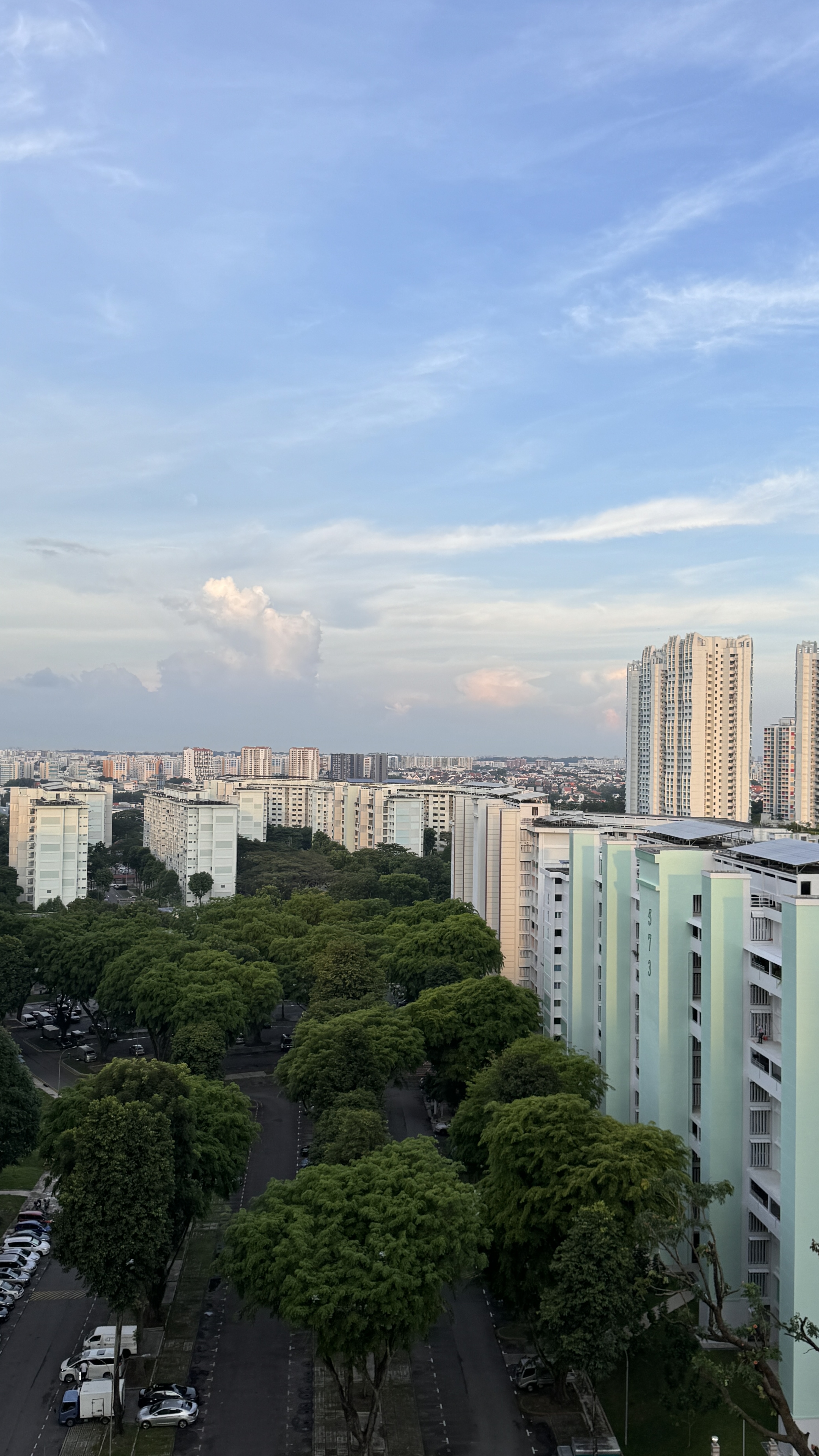 Welcome to the Service Yard Tour! - Towering apartment buildings with lush green trees lining the streets, Cityscape