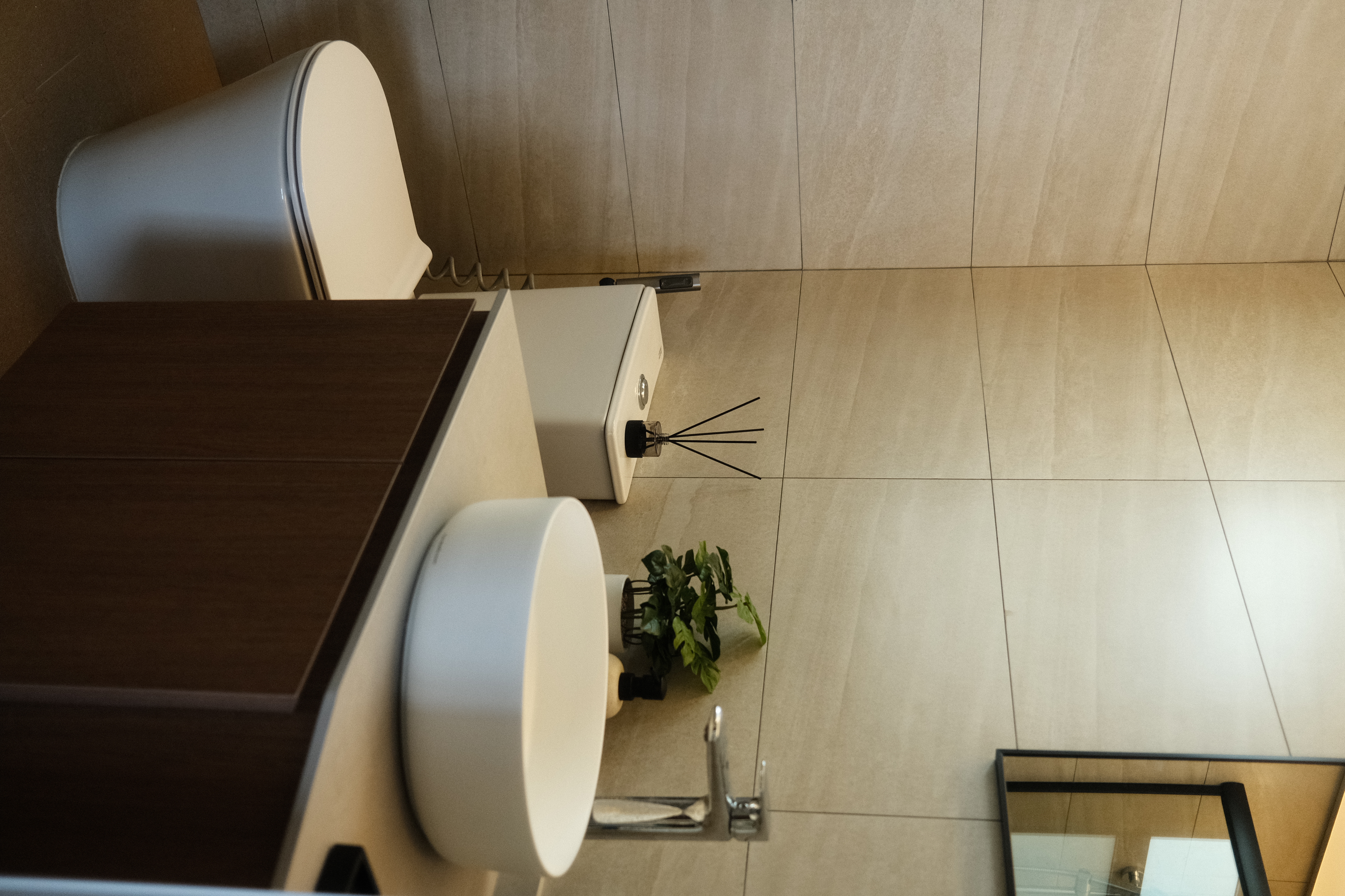 Balancing cost with aesthetics in our bathrooms  - modern bathroom, minimalist design, white toilet, wooden cabinet, beige