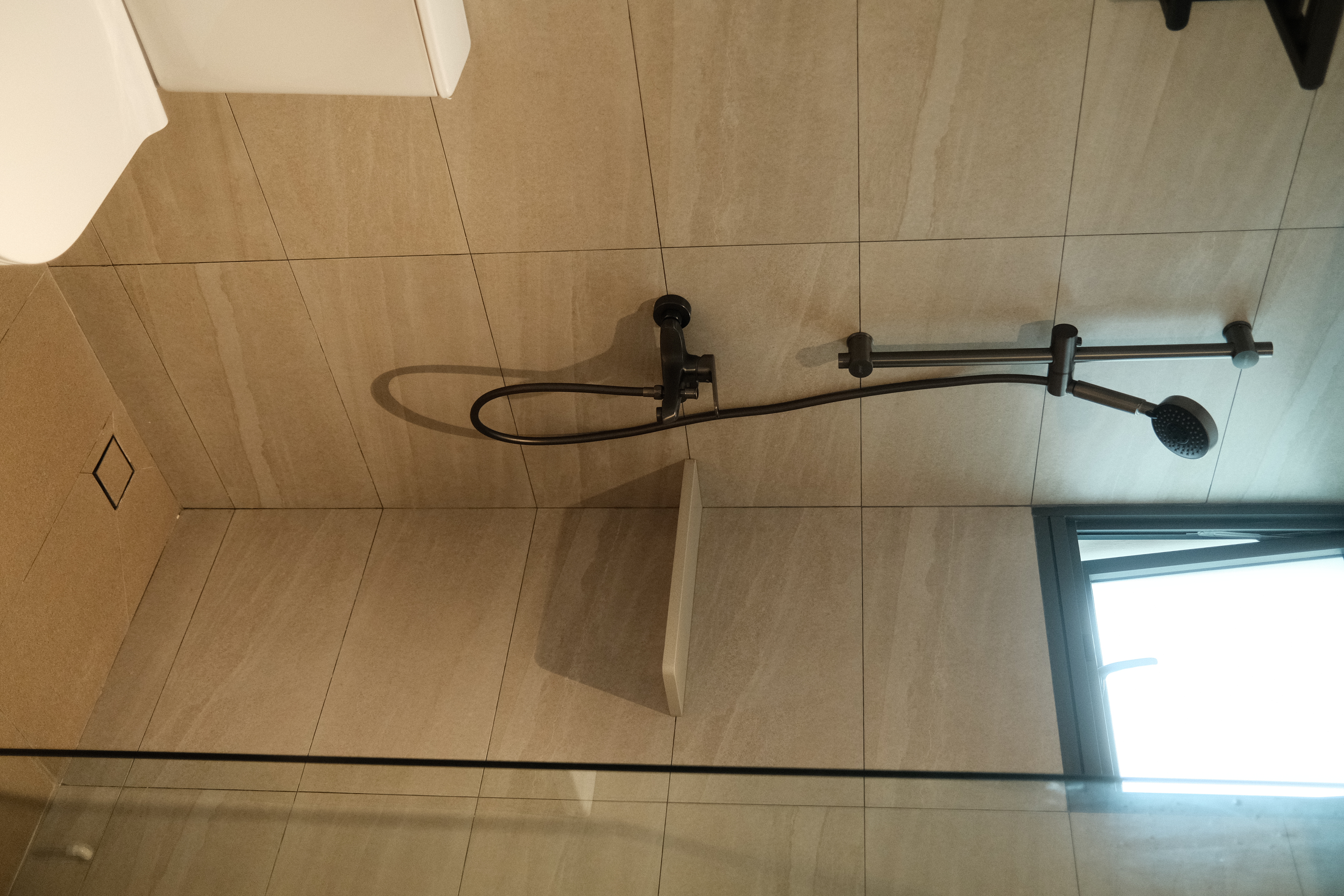 Balancing cost with aesthetics in our bathrooms  - Modern bathroom, tiled floor, beige tiles, sleek fixtures, black shower