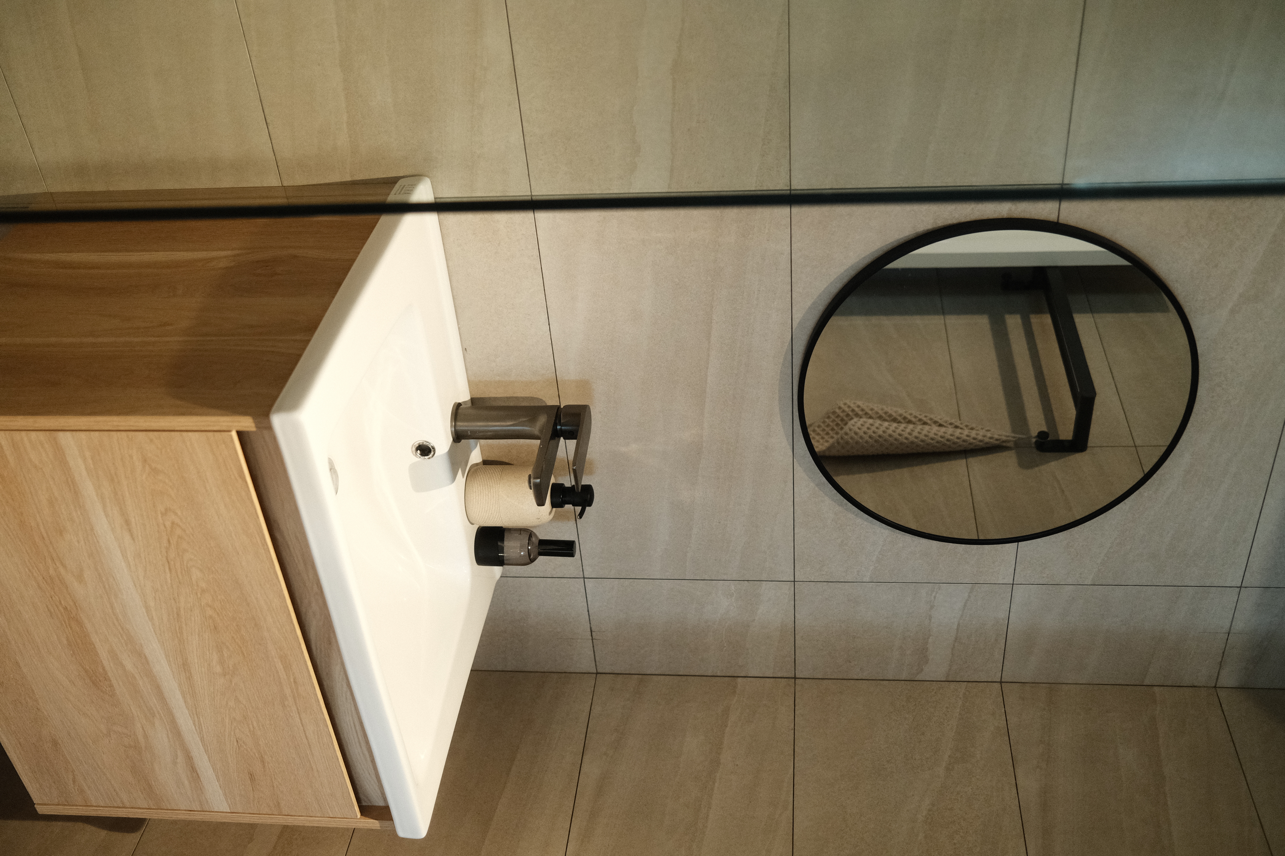 Balancing cost with aesthetics in our bathrooms  - Bathroom vanity, toilet paper holder, wooden vanity, white sink, mirror