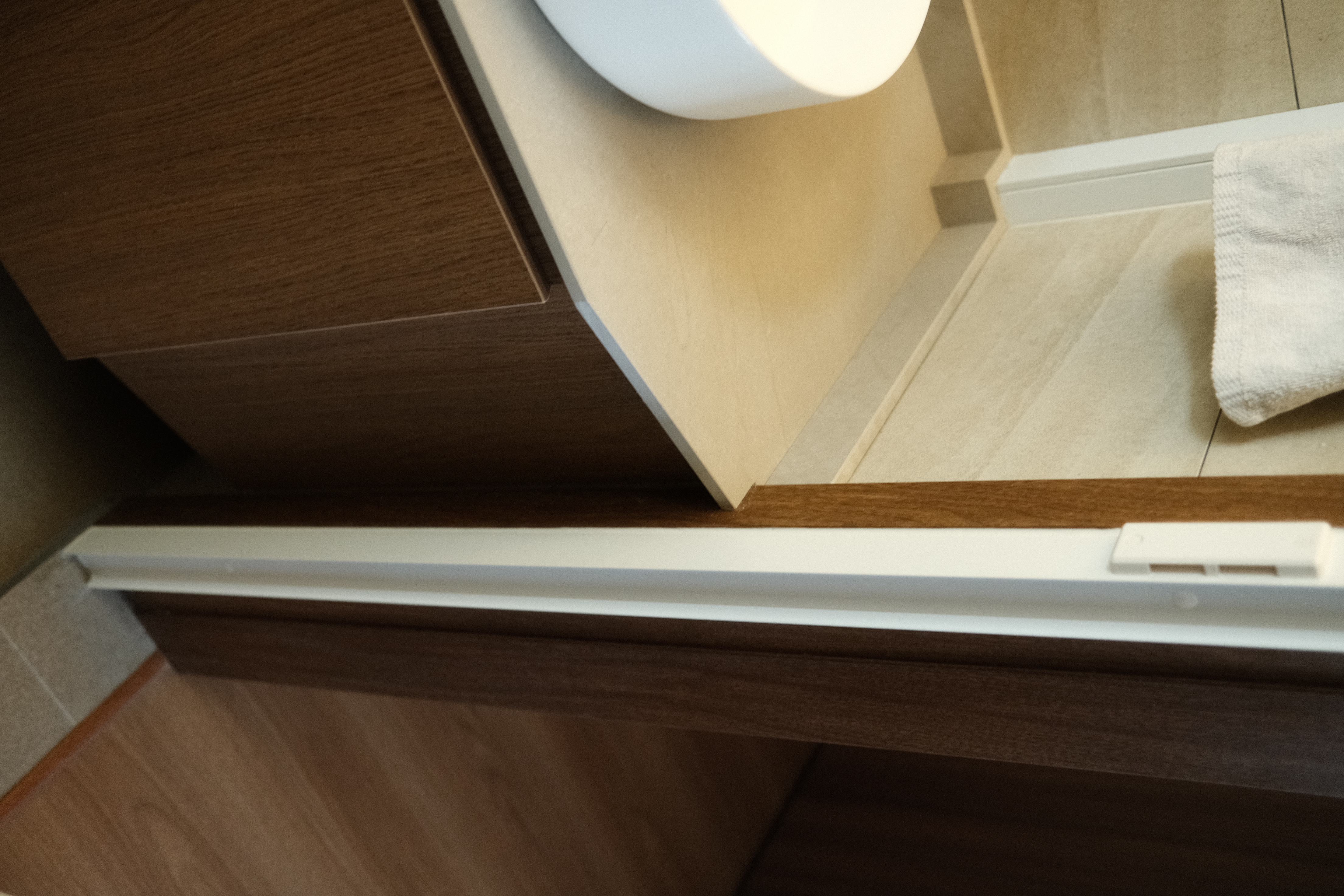 Balancing cost with aesthetics in our bathrooms  - Wooden cabinet, beige tiles, white sink, wooden drawer, white handle