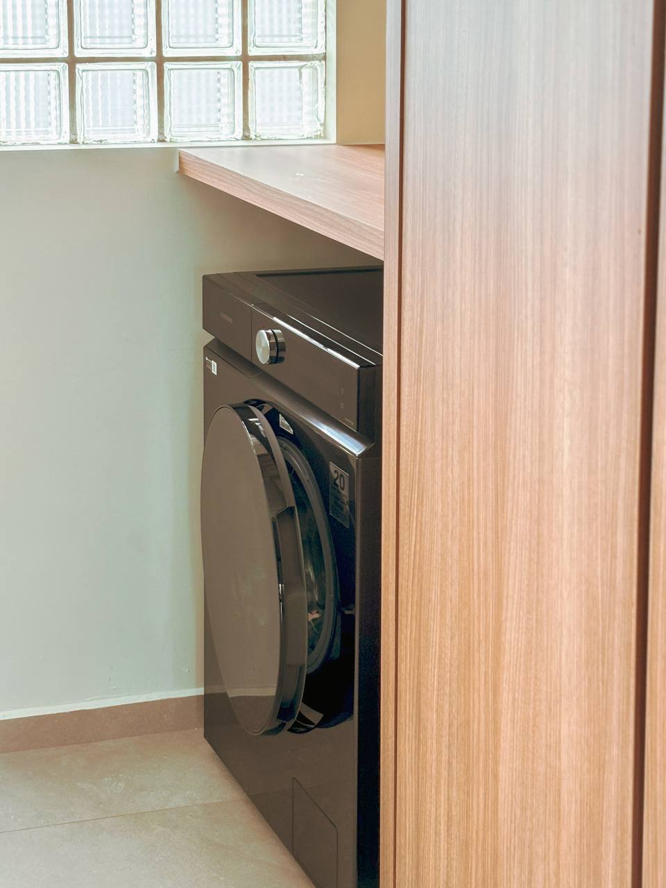 Keeping it Minimalist - Service Yard - Dedicated laundry room, modern washing machine, wooden cabinet, tiled floor, small