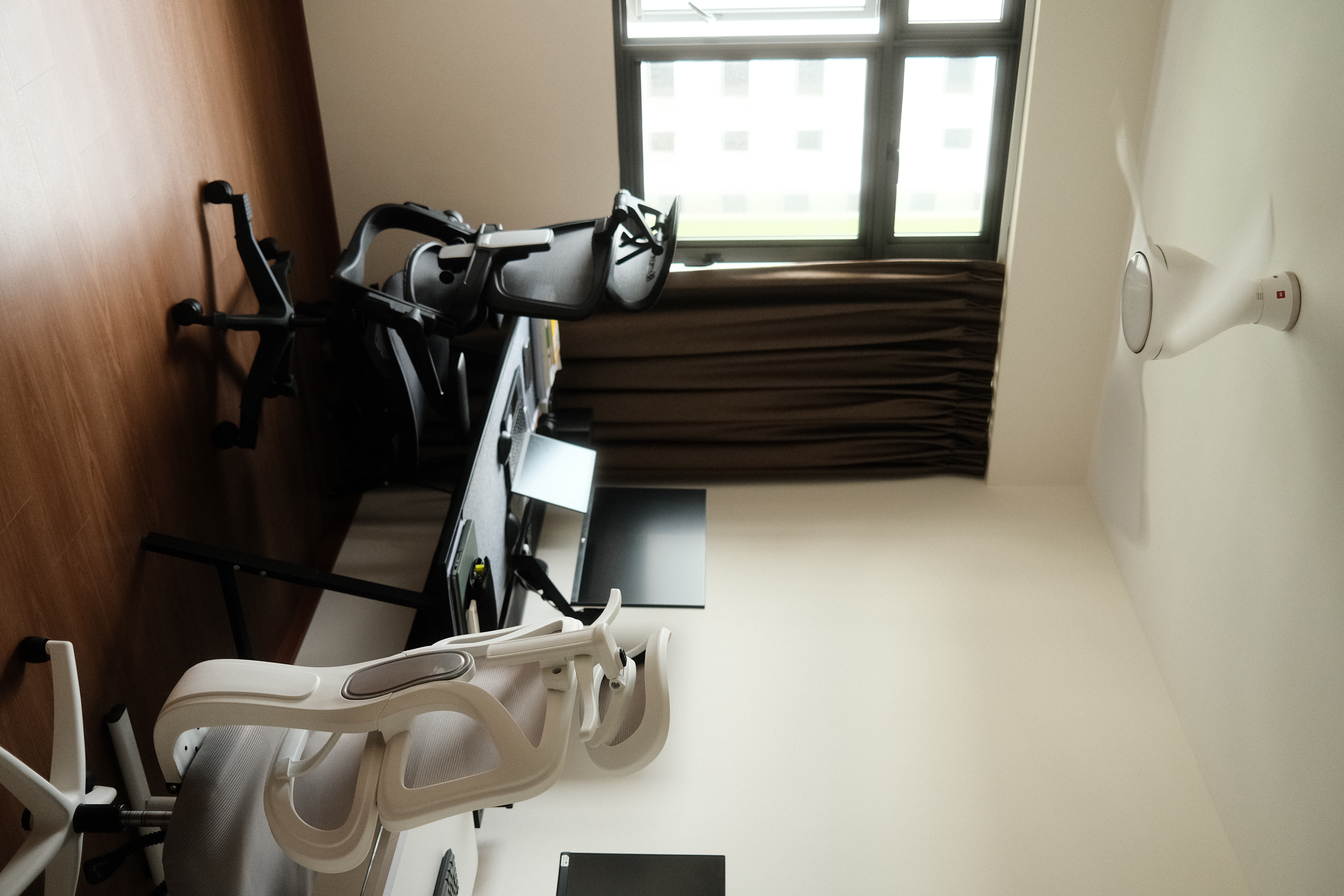 Our simple and minimal workspace - Wooden wall, ergonomic chair, exercise equipment, black chair, white chair, exercise