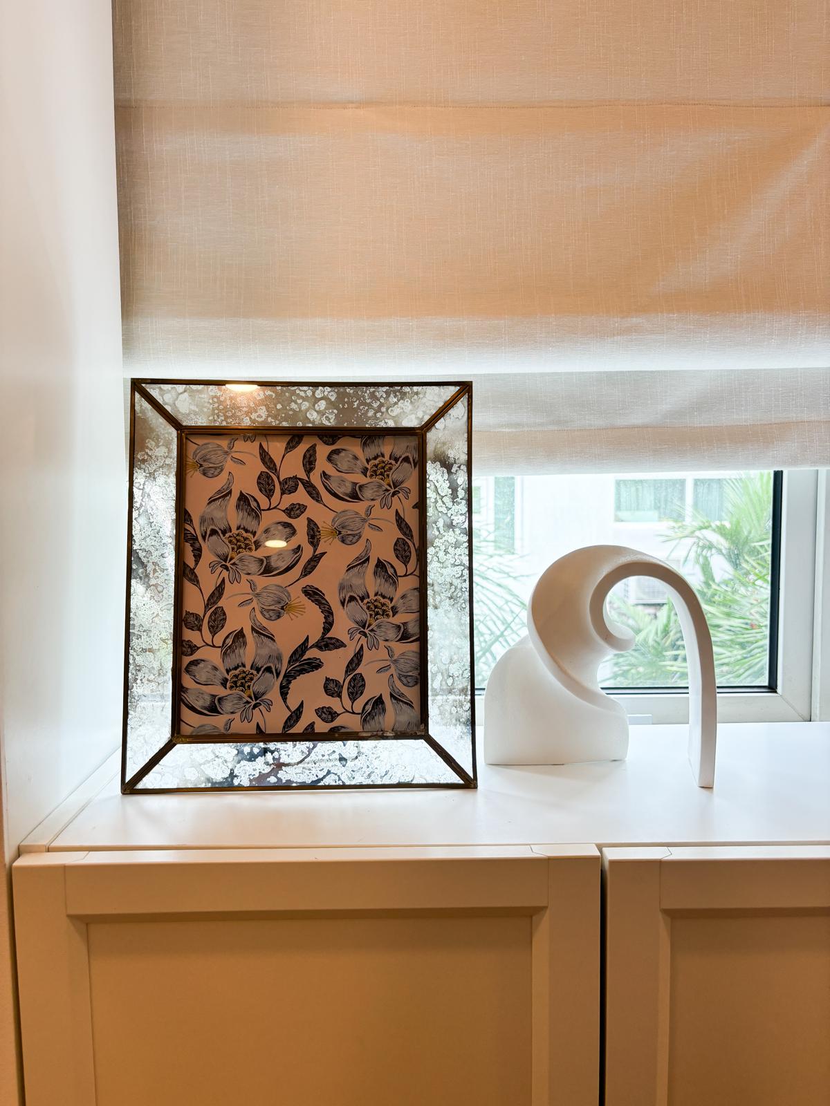 A comfortable and clutter-free WFH workspace to inspire productivity  - Elegant floral pattern frame on white countertop