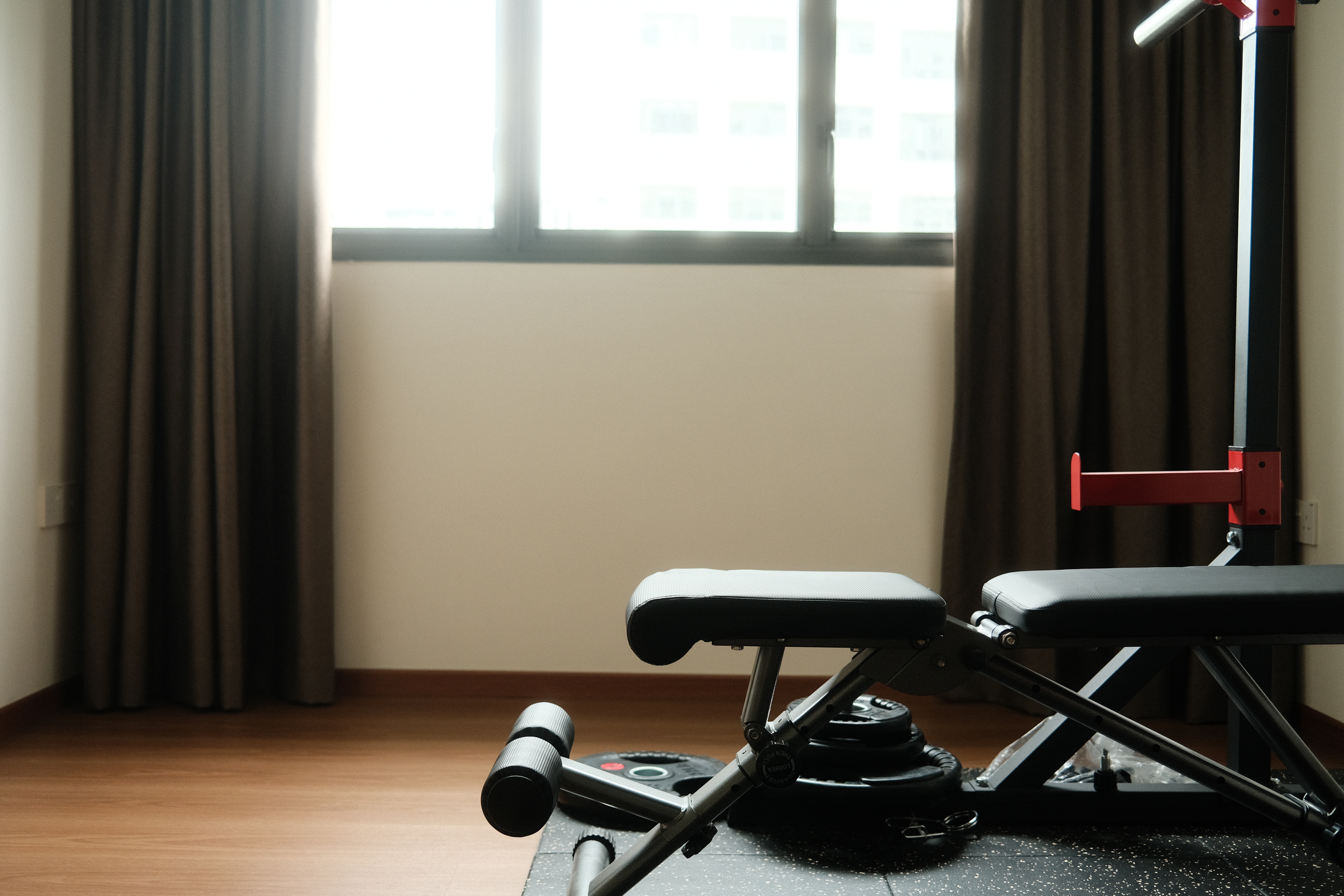 Trying to be healthy in our home gym - black exercise bench, black cushion, black seat, black footrest, gym equipment