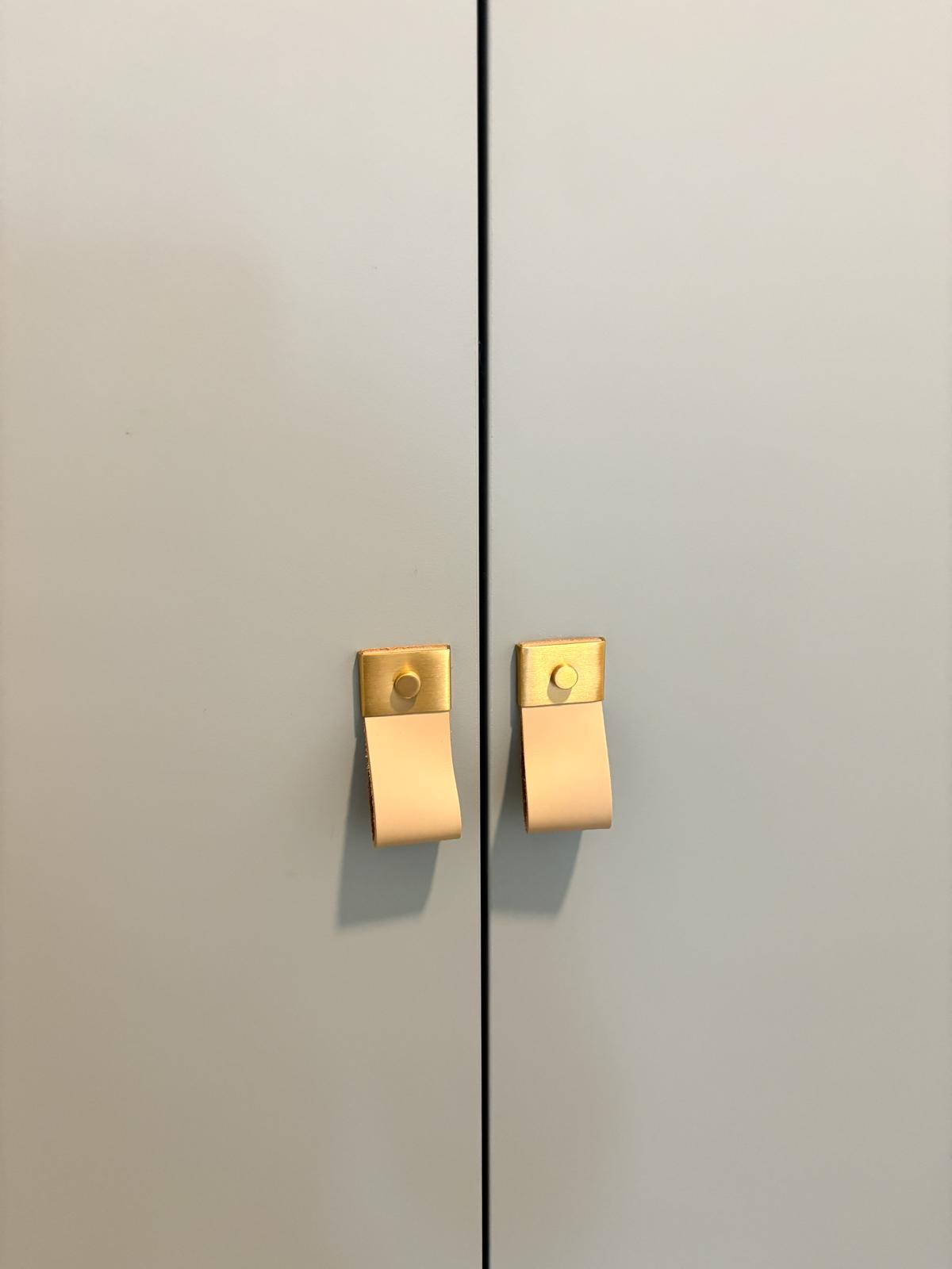 A safari themed kid's room  - Gold hinges, minimalist design, rectangular paper towel holder, two-tone color scheme, sleek