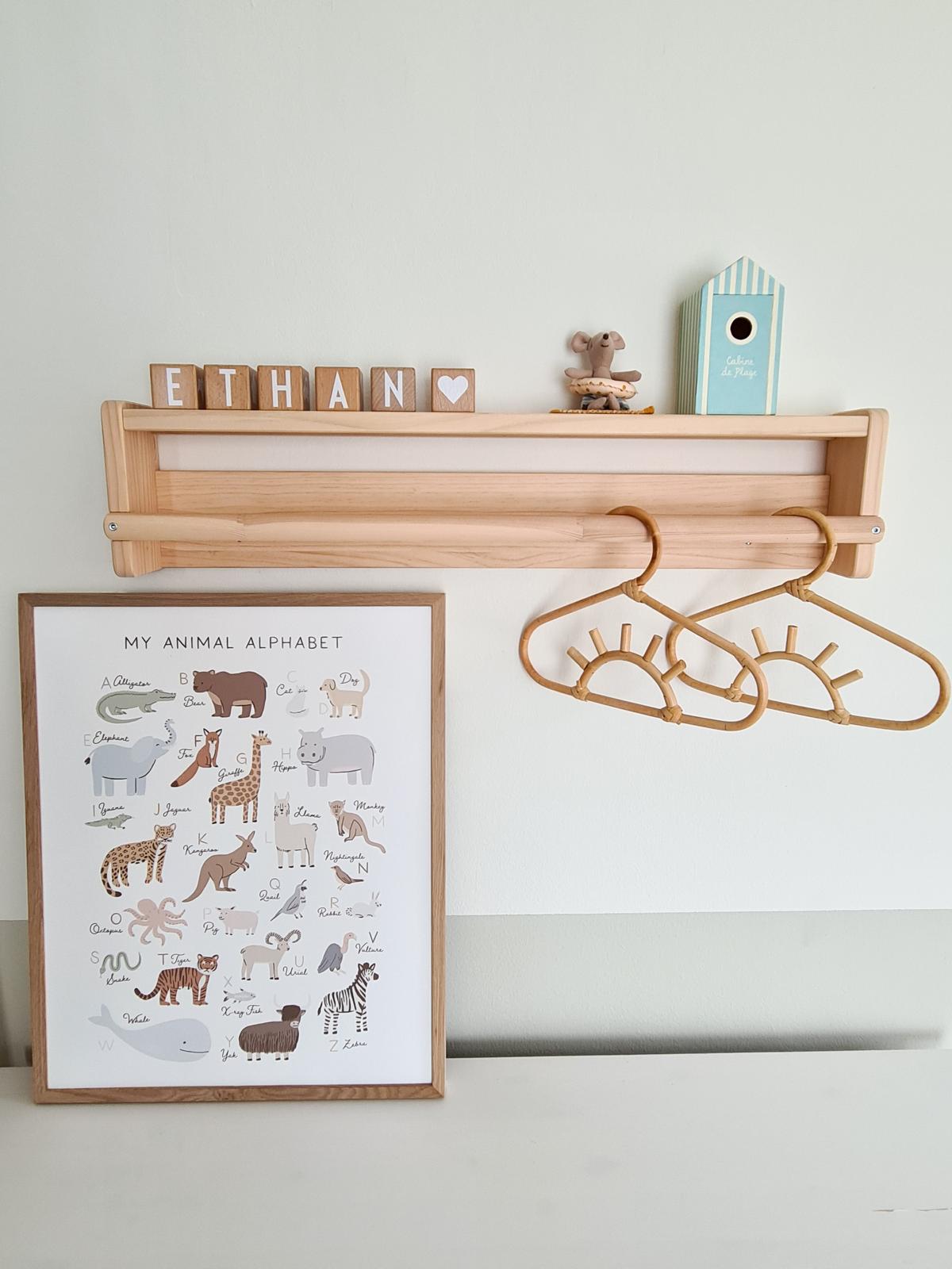 A safari themed kid's room  - Wooden animal alphabet chart, "ETHAN" sign, wooden birdhouse, mouse figurine, wooden hanger