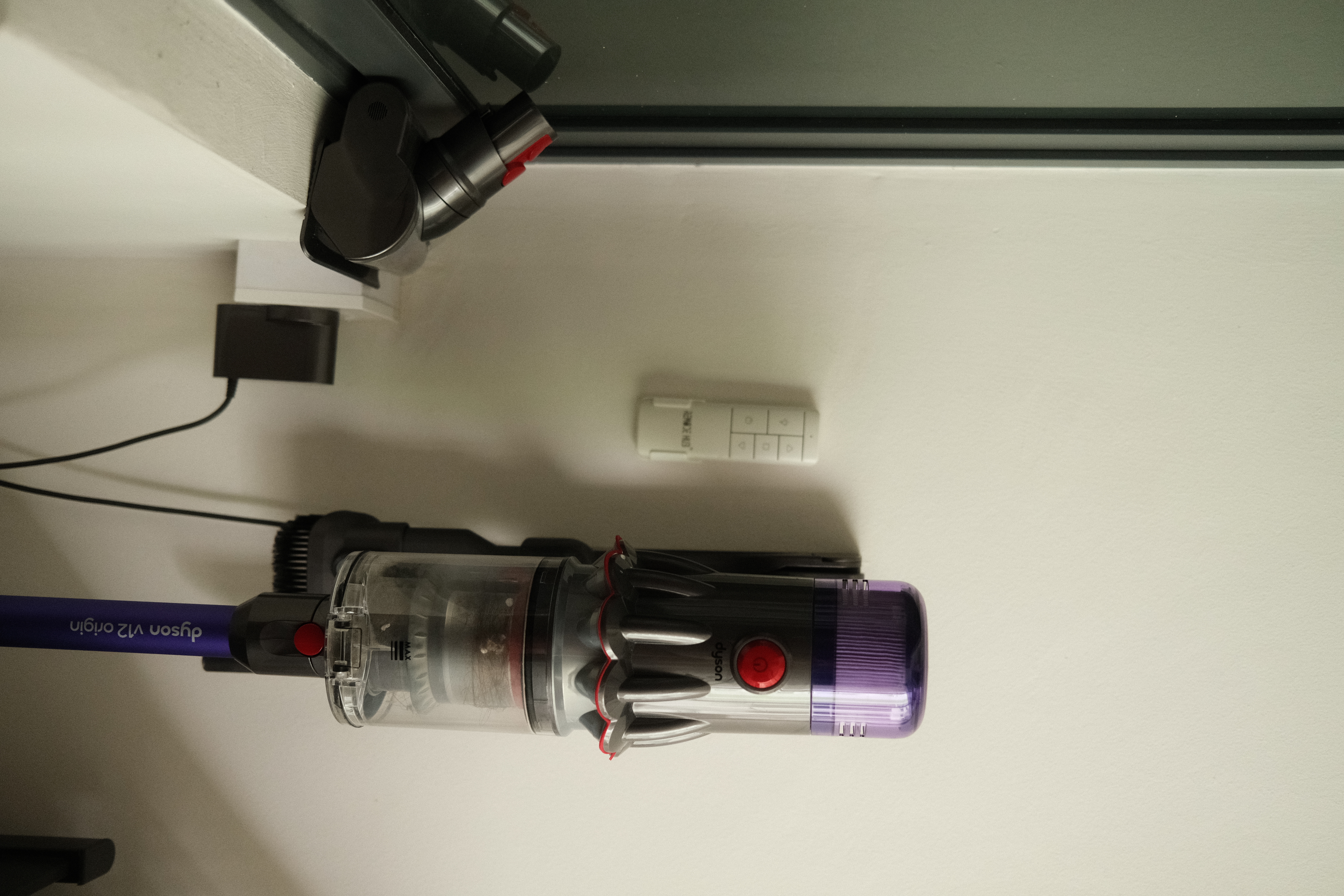 Organising our service yard - Vacuum cleaner, cord, power adapter, remote control, digital display, control buttons, suction