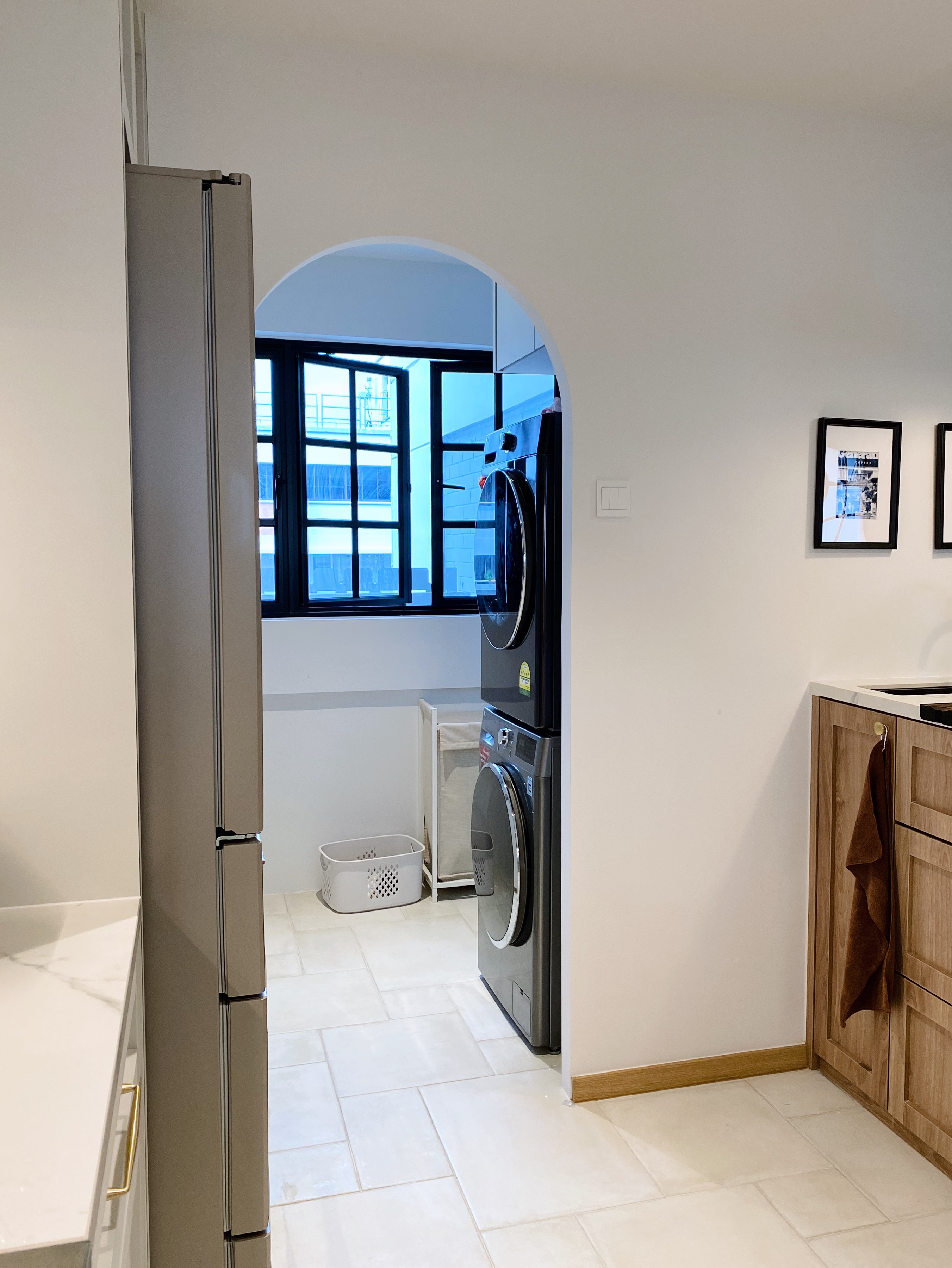 Spoilt by the service yard experience - Modern kitchen with stainless steel refrigerator, white tiled floor, wooden cabinets