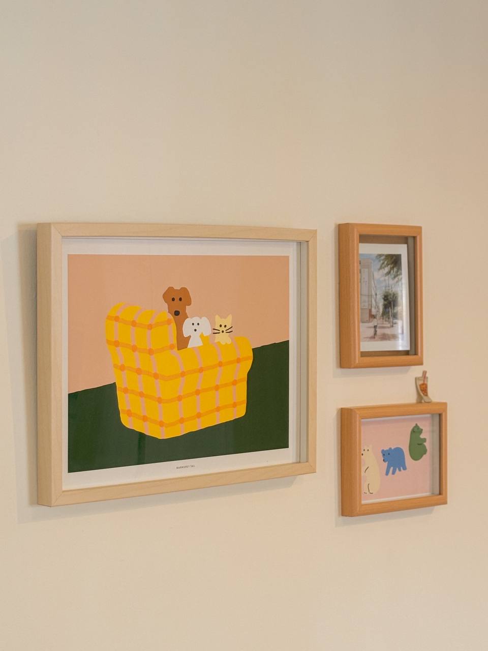 The Art in Our Home - Cartoon-style illustration of a yellow checkered sofa with three animals, including a dog, cat, and