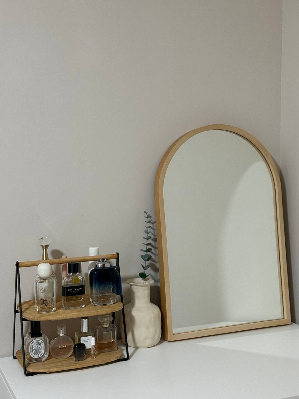 Extra Room: Rattan inspired - Wooden shelf, elegant arrangement, small potted plant, minimalist decor, vintage perfume