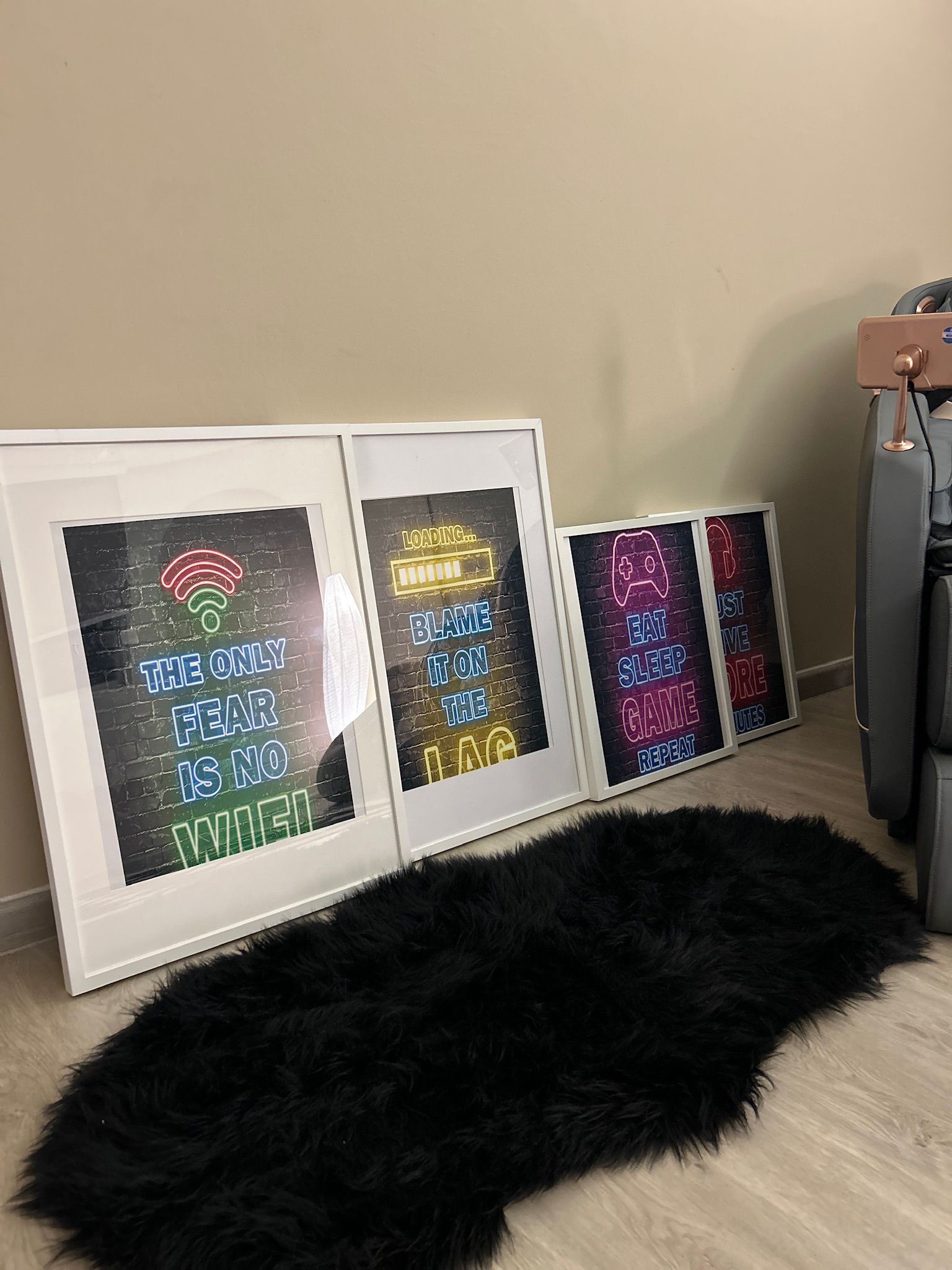 From Bedroom to Entertainment room - Neatly arranged neon signs on a black rug, Framed posters with bold, colorful text, Wall