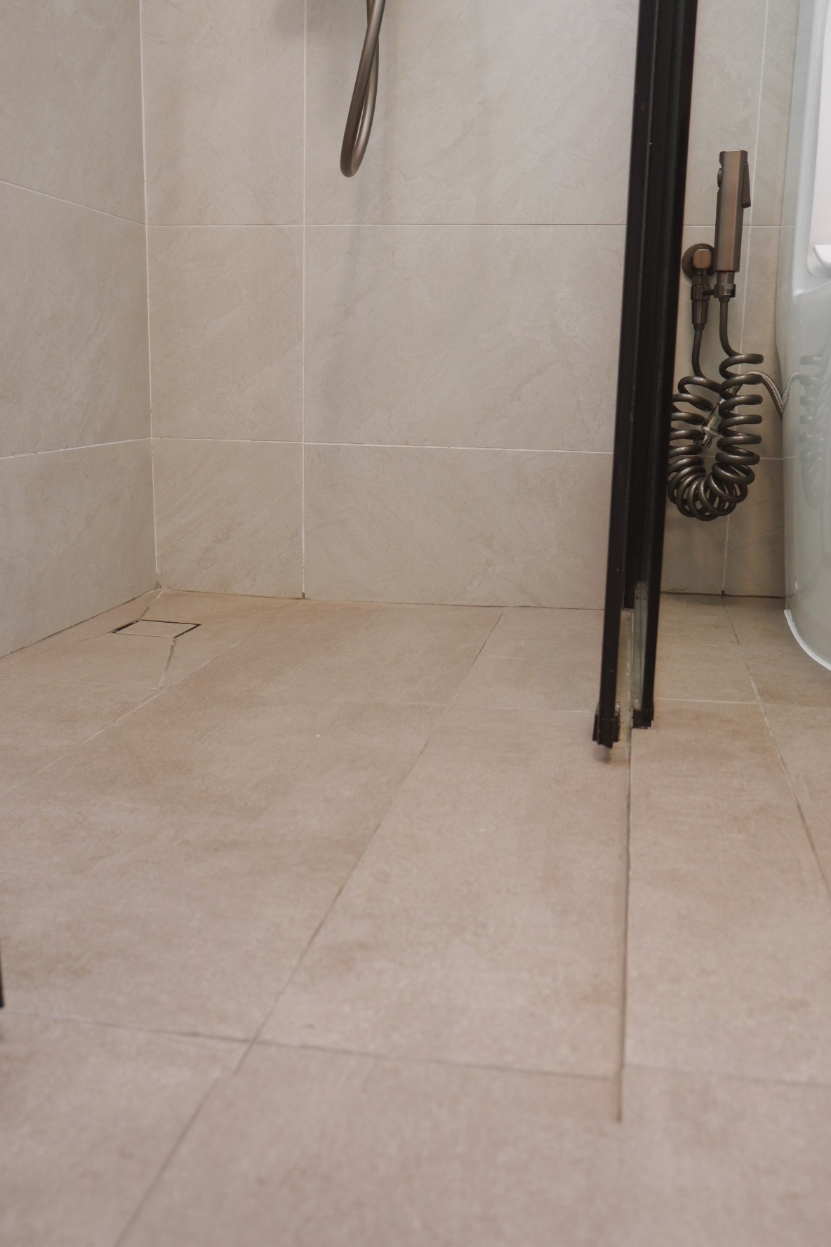 Our Bathrooms: My husband and I designed a bathroom each - Beige tiled bathroom, modern showerhead, coiled hose, beige tiles