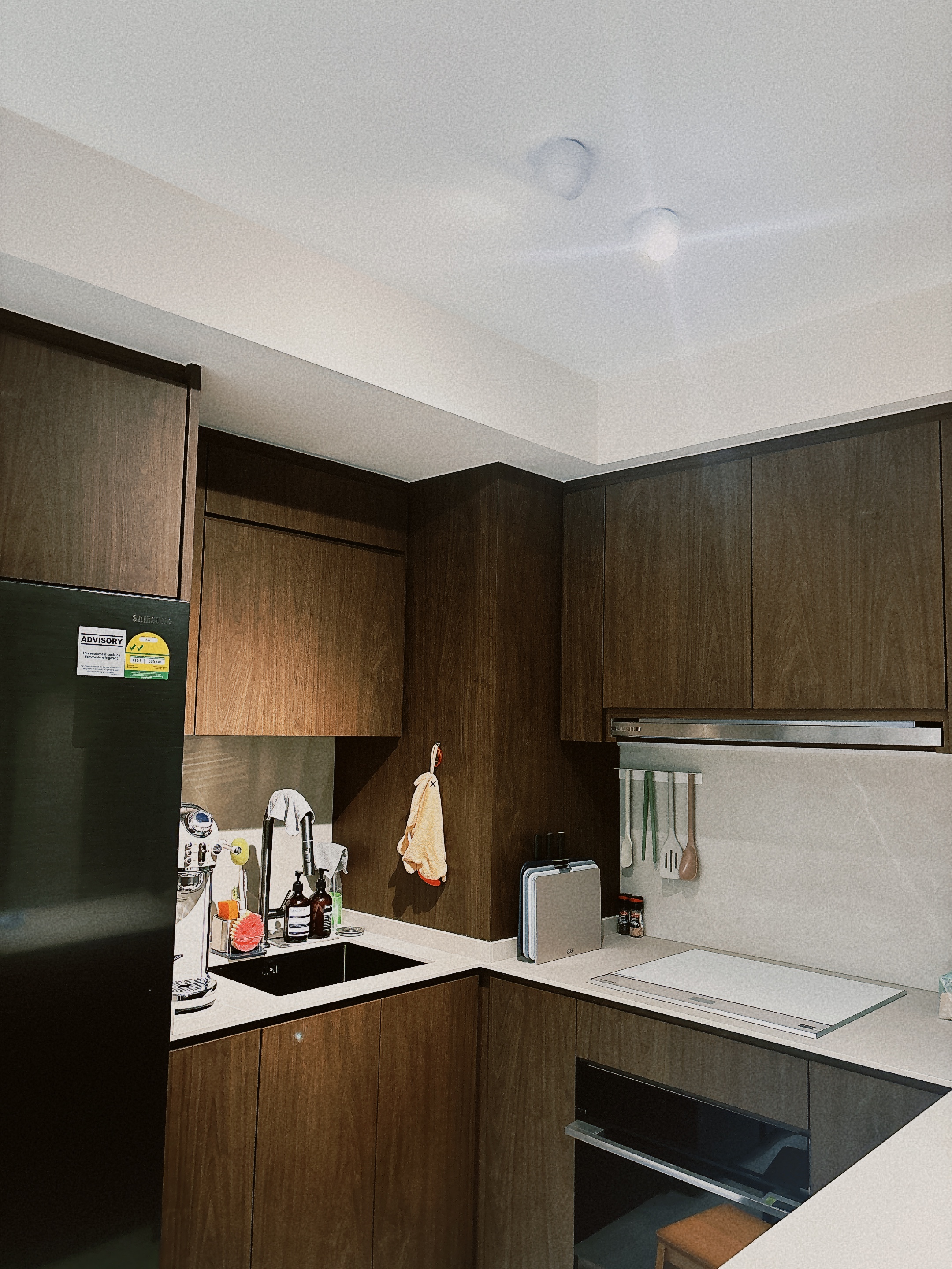 Keeping things simple when you can’t decide  - Wooden kitchen cabinets, modern design, dark brown finish, sleek appliances