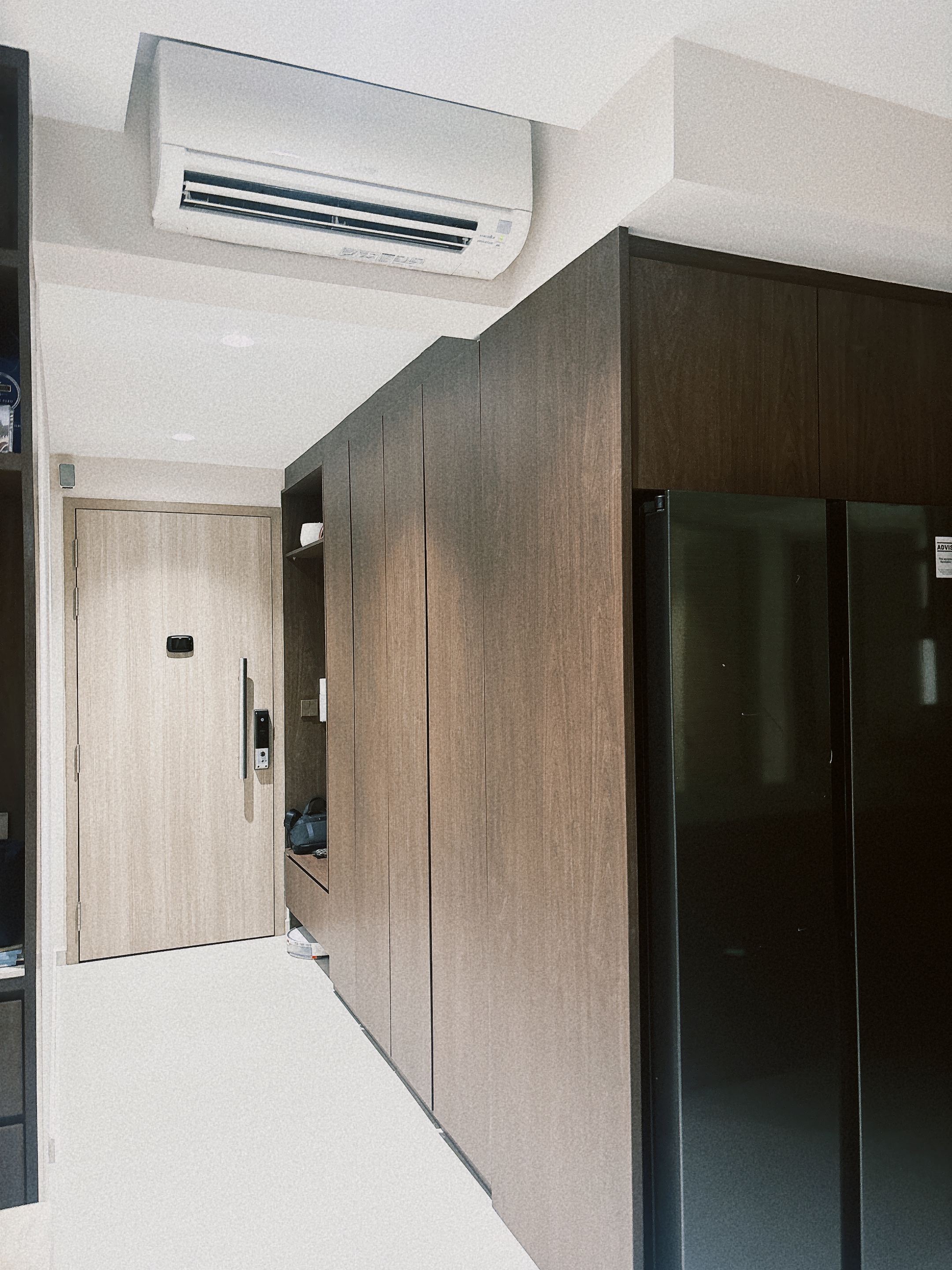 Entryway to our home! - Wooden door, air conditioning unit, modern kitchen cabinetry, dark brown wood, sleek design