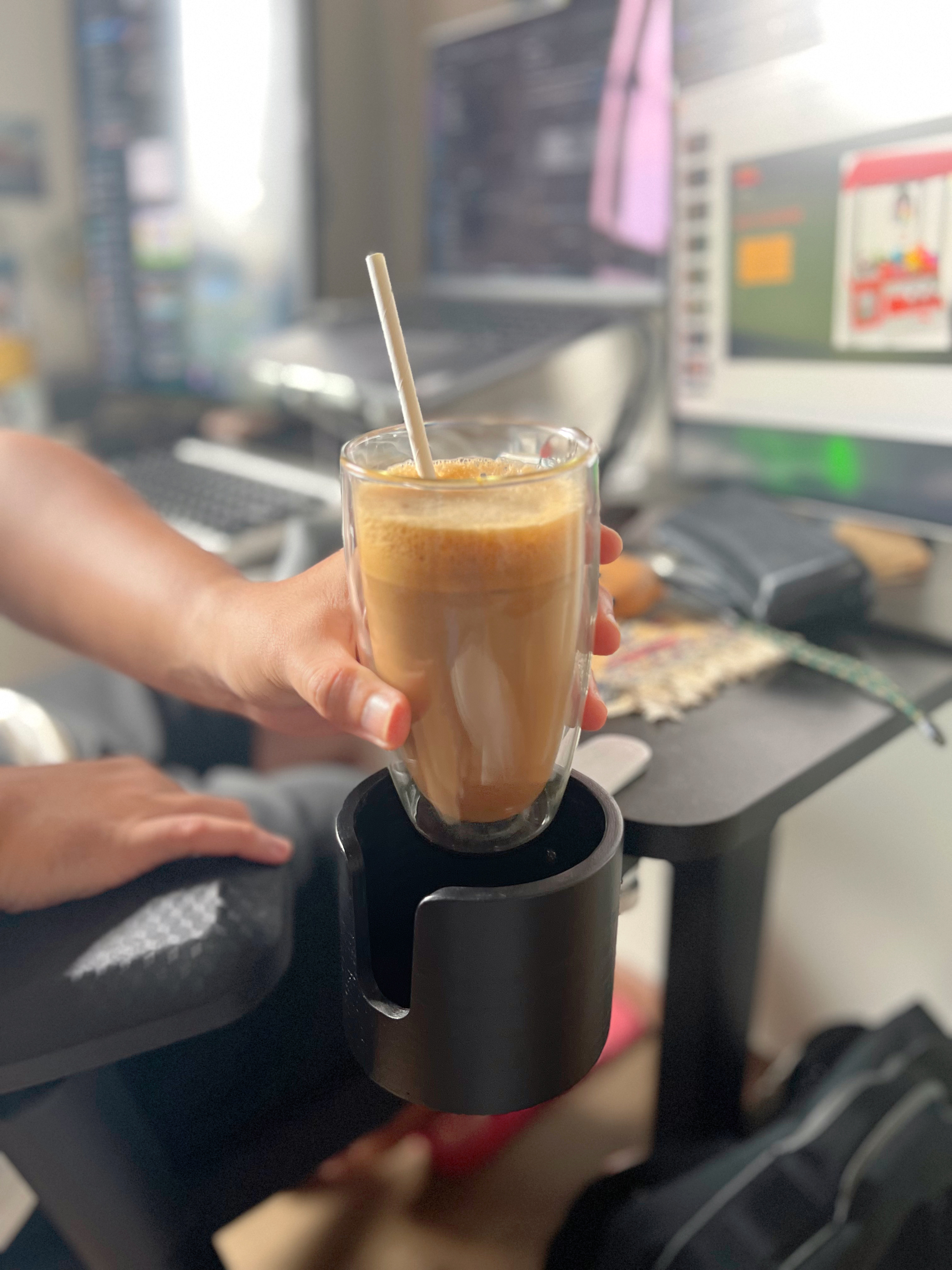 His and Hers WFH set-up - glass coffee, coffee machine, person holding glass, pouring coffee, coffee cup, coffee machine