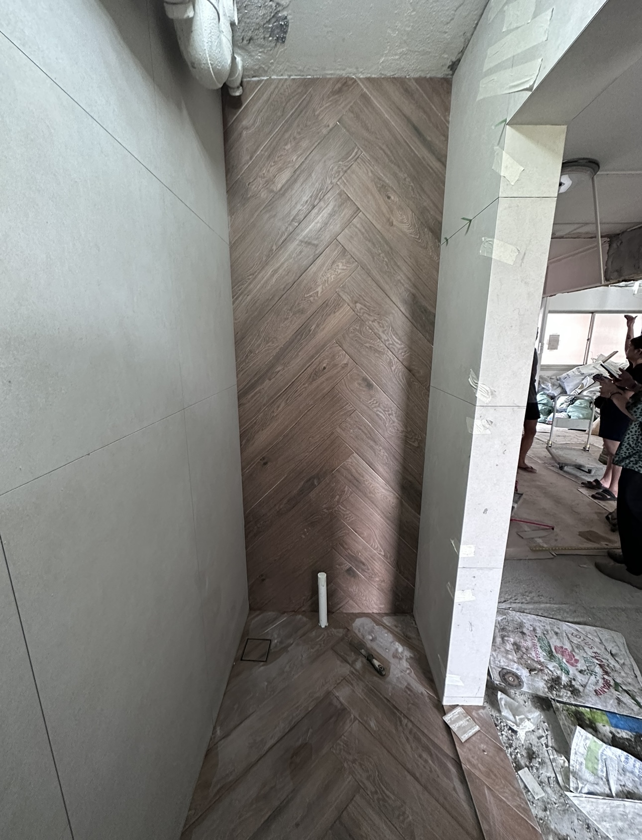 Join us in building our 3 bathrooms! - Herringbone pattern wooden floor, unfinished walls, herringbone wood herringbone