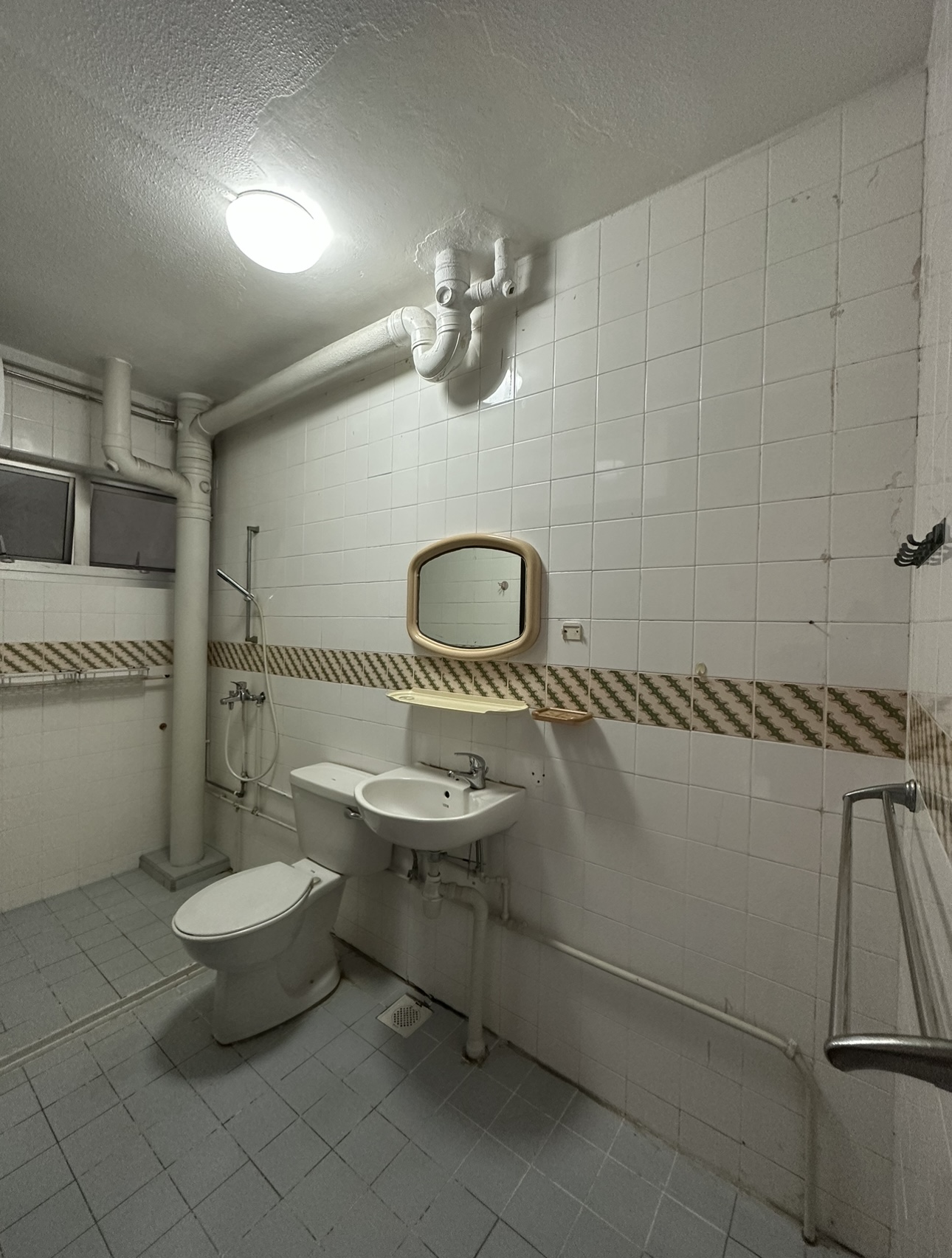 Join us in building our 3 bathrooms! - White tiled bathroom, tiled walls, white toilet, white sink, beige-framed mirror