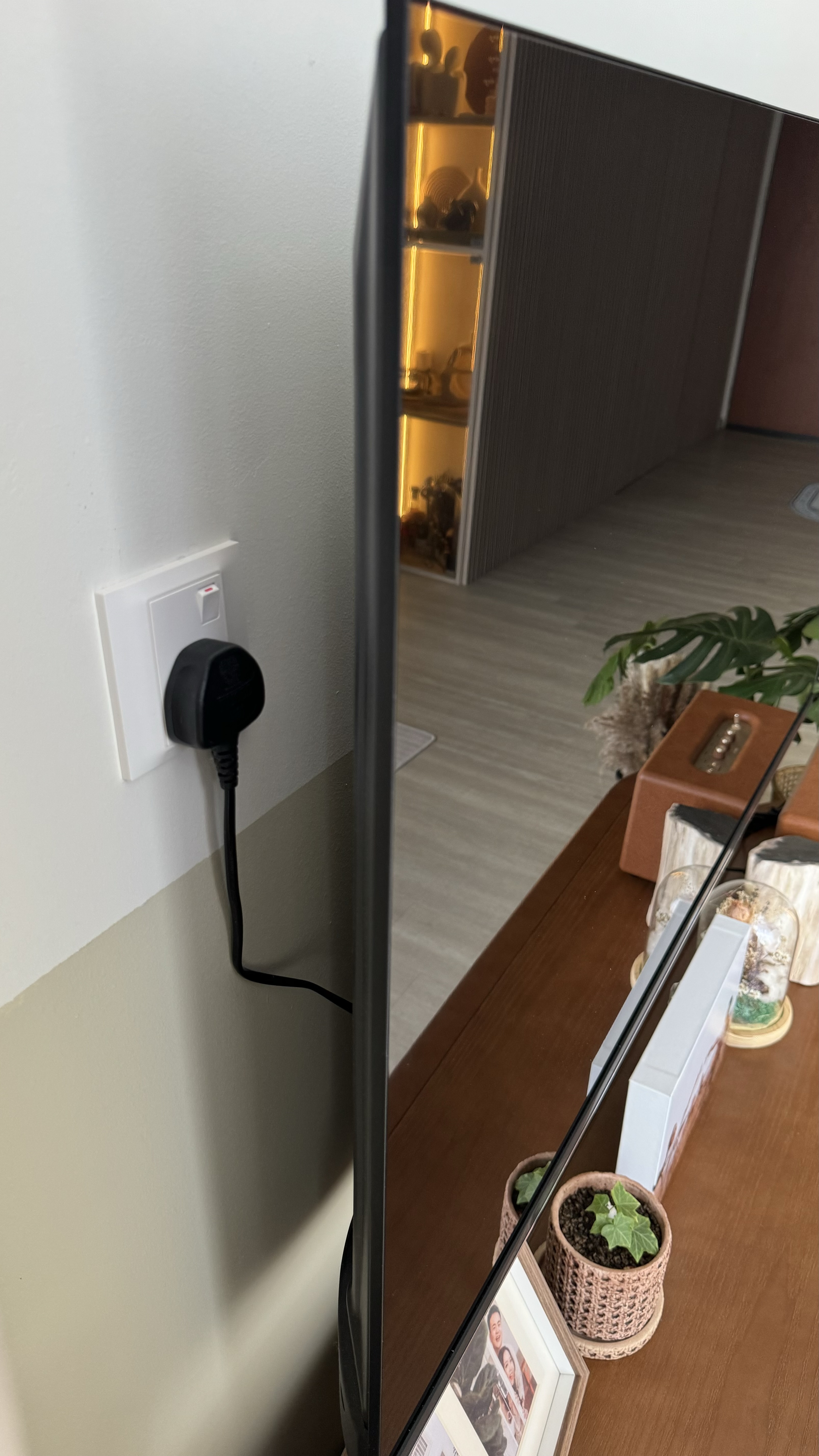 Our Secrets to Cable-Free TV Setup 📺  - Power cord plugged into wall socket, modern interior setting, wooden table with