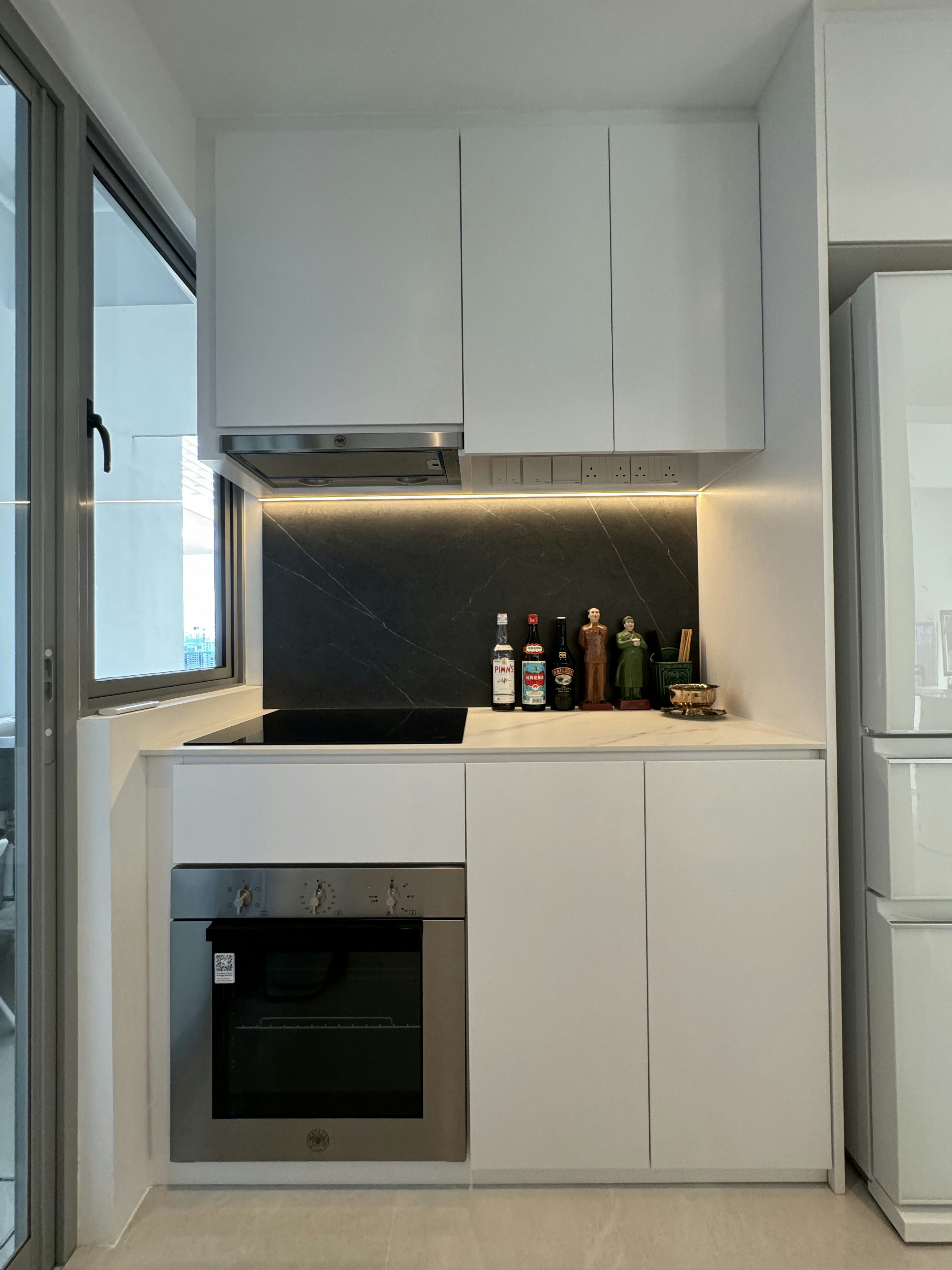 Masak-Masak @ Rumah Beacon - White kitchen cabinetry, modern appliances, black countertop, stainless steel oven, built-in