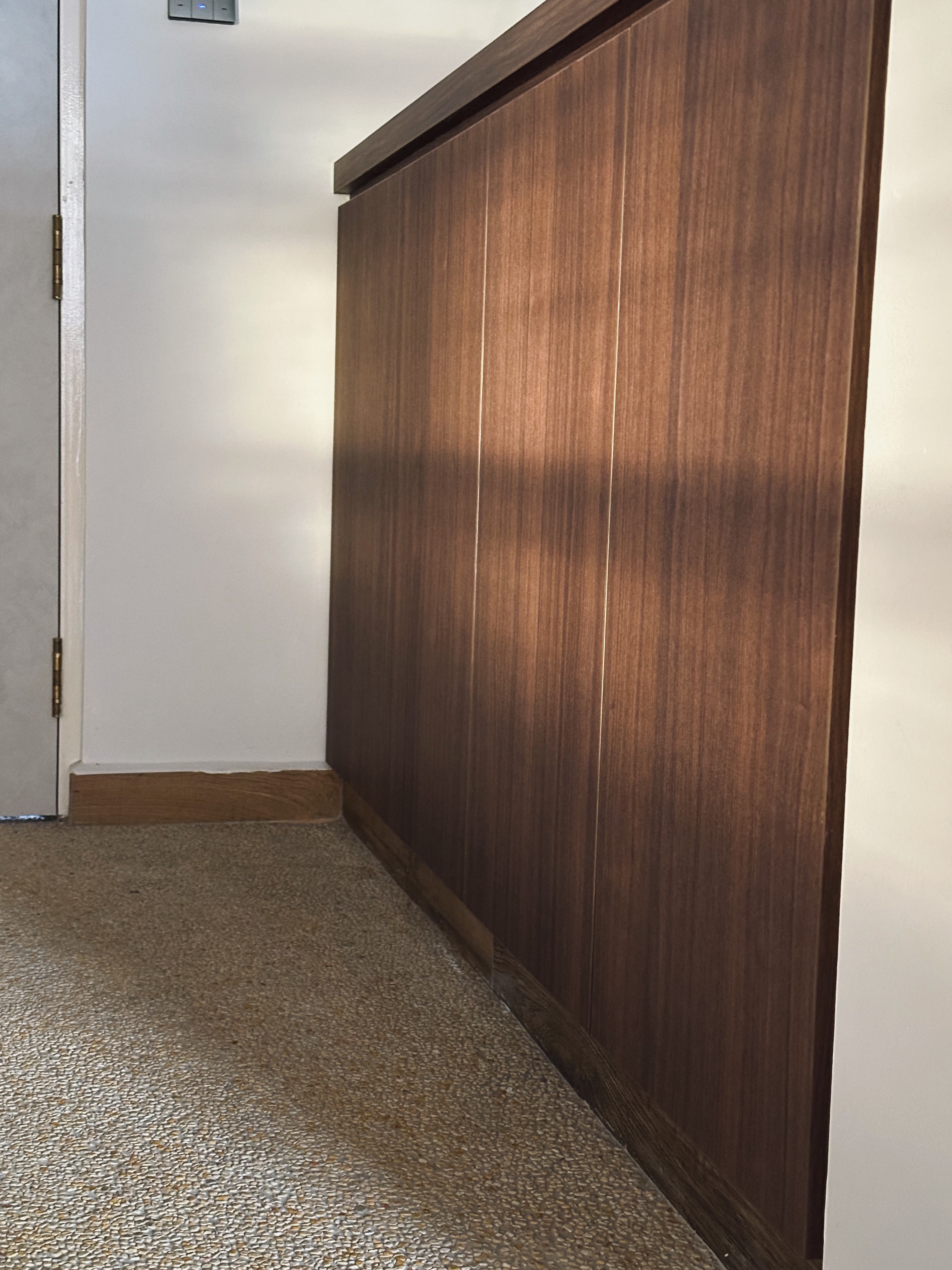 Our Entryway: "Hey Siri, I'm home"  - Wooden cabinet, dark wood finish, textured floor, small room, corner, light switch