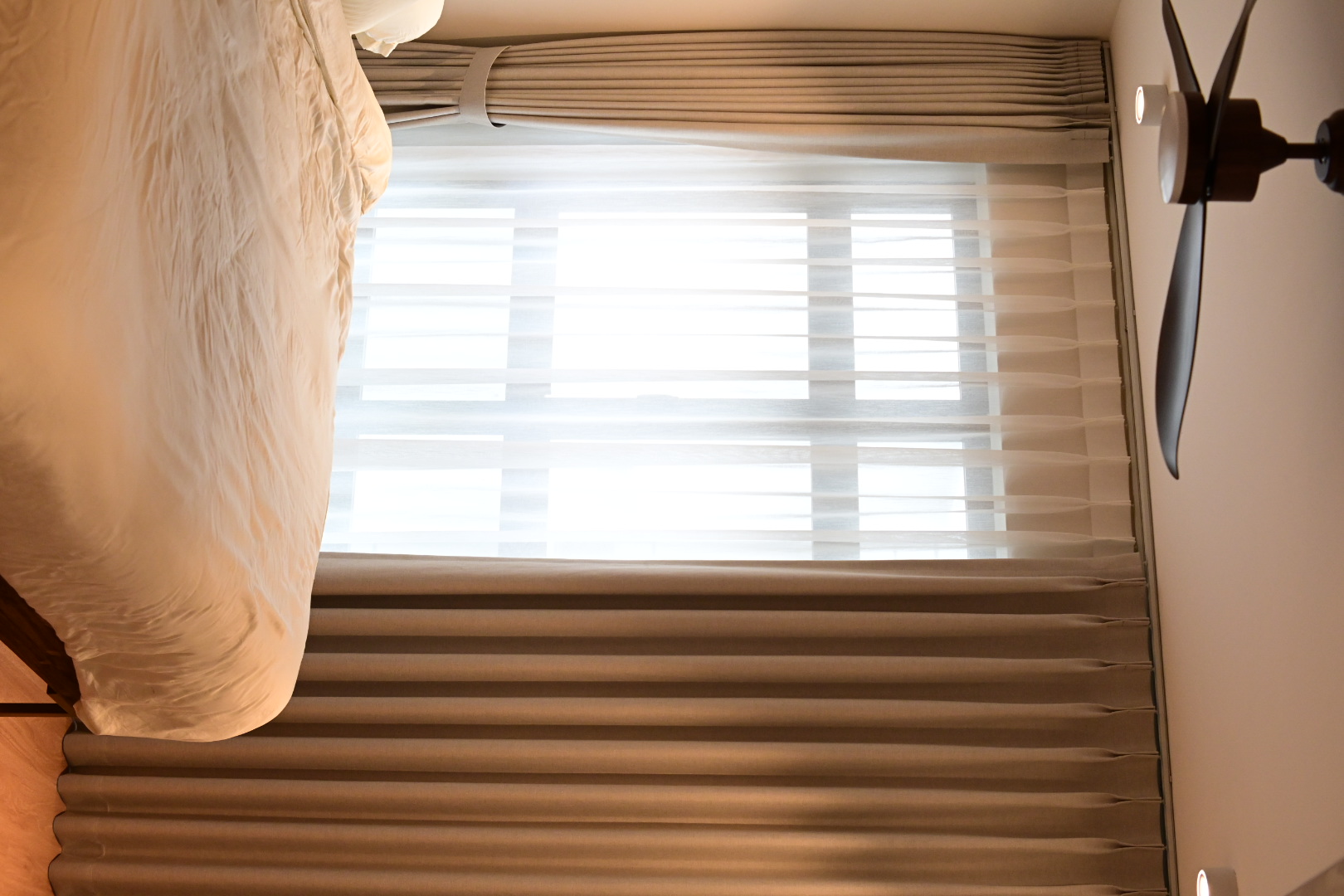 Our bedroom - the most comfortable space in the house  - Soft beige bedding, beige curtains, window with blinds, light