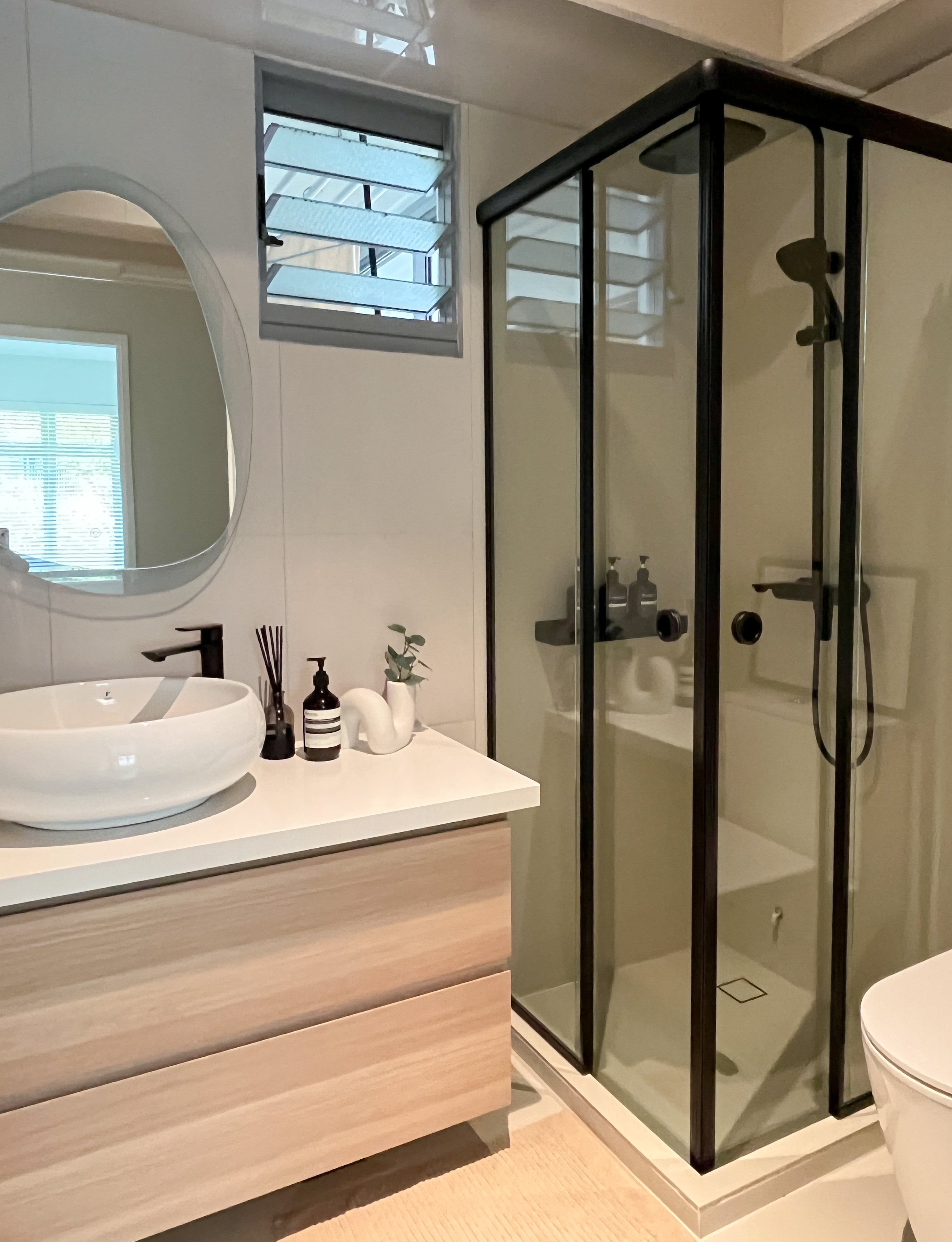 Our Bathroom Space - White oval sink, modern bathroom, floating vanity, wooden drawers, sleek mirror, black faucet, glass