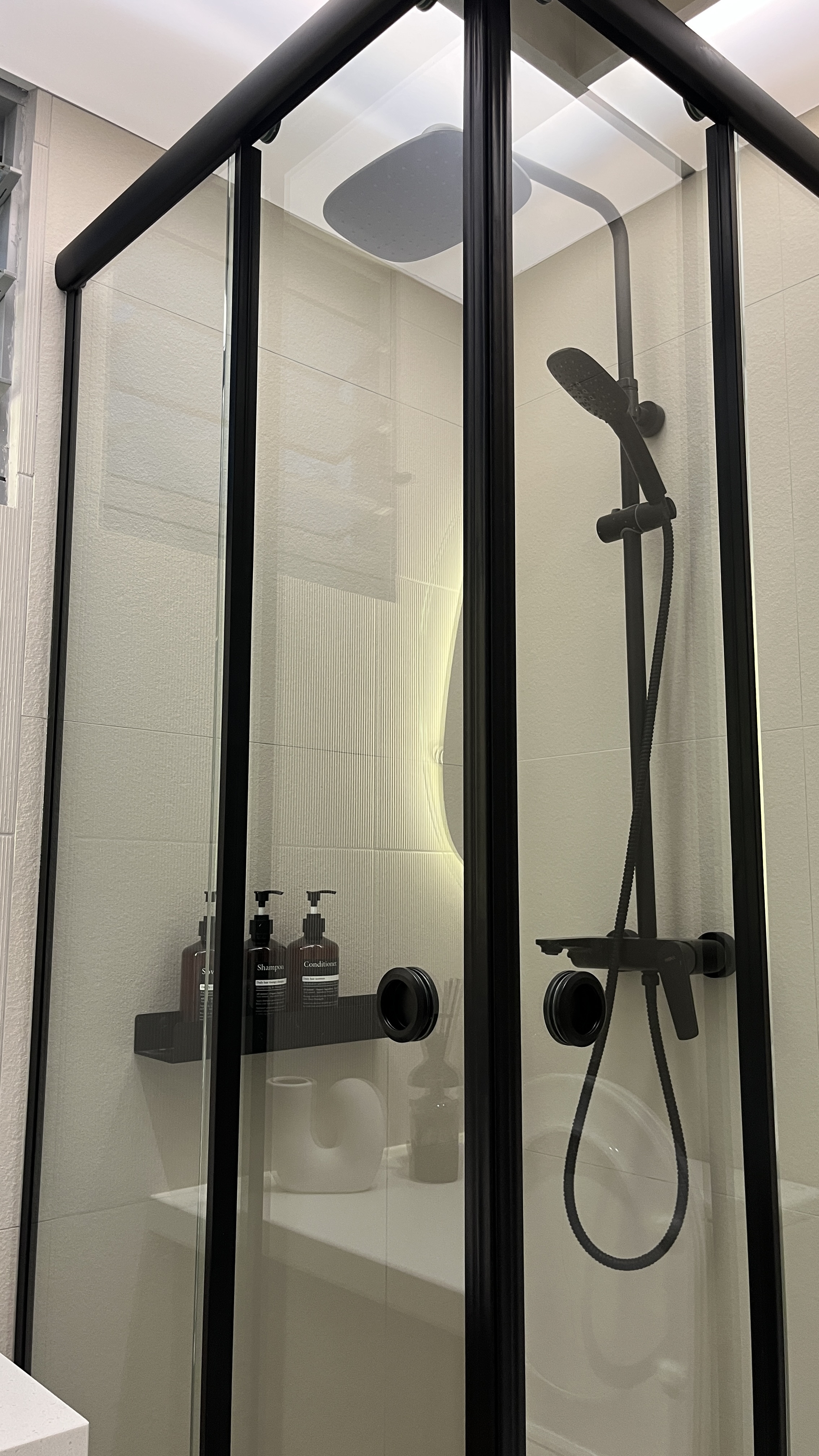 Our Bathroom Space - Glass shower enclosure, modern design, black frame, sleek lines, minimalist aesthetic, built-in shower