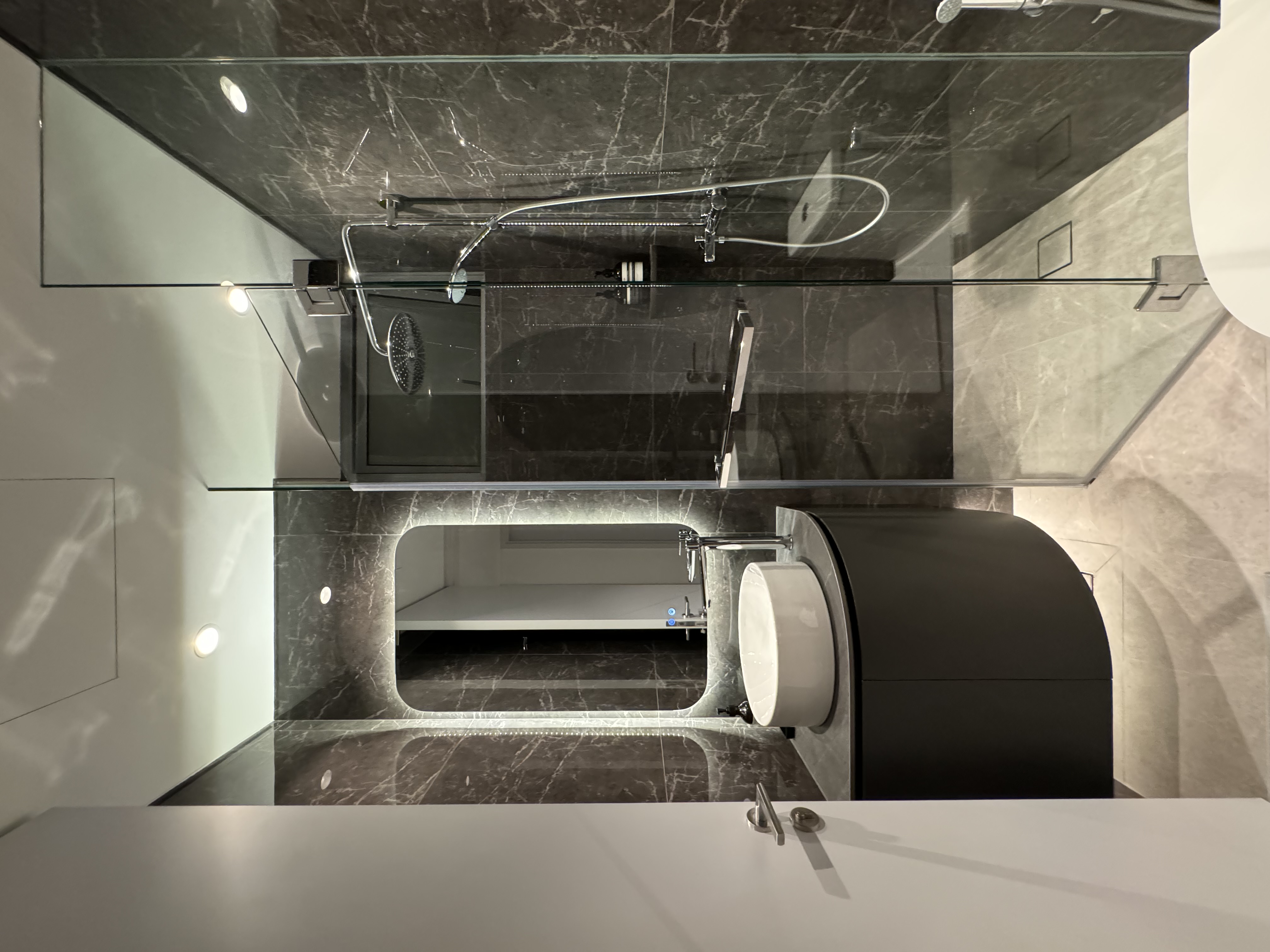 Scrub-A-Dub-Dub In Style - Modern bathroom interior, sleek design, dark marble walls, glass shower enclosure, contemporary