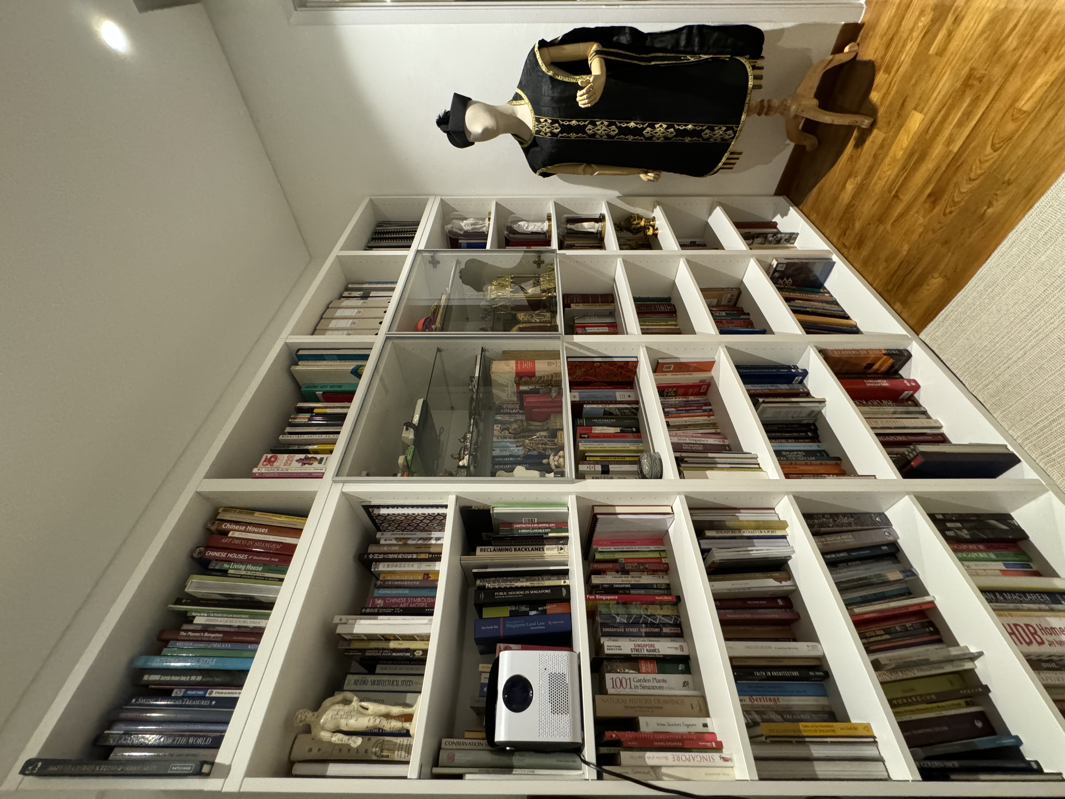 Study @ Rumah Beacon - White bookshelf filled with a diverse collection of books, including fiction and non-fiction genres.