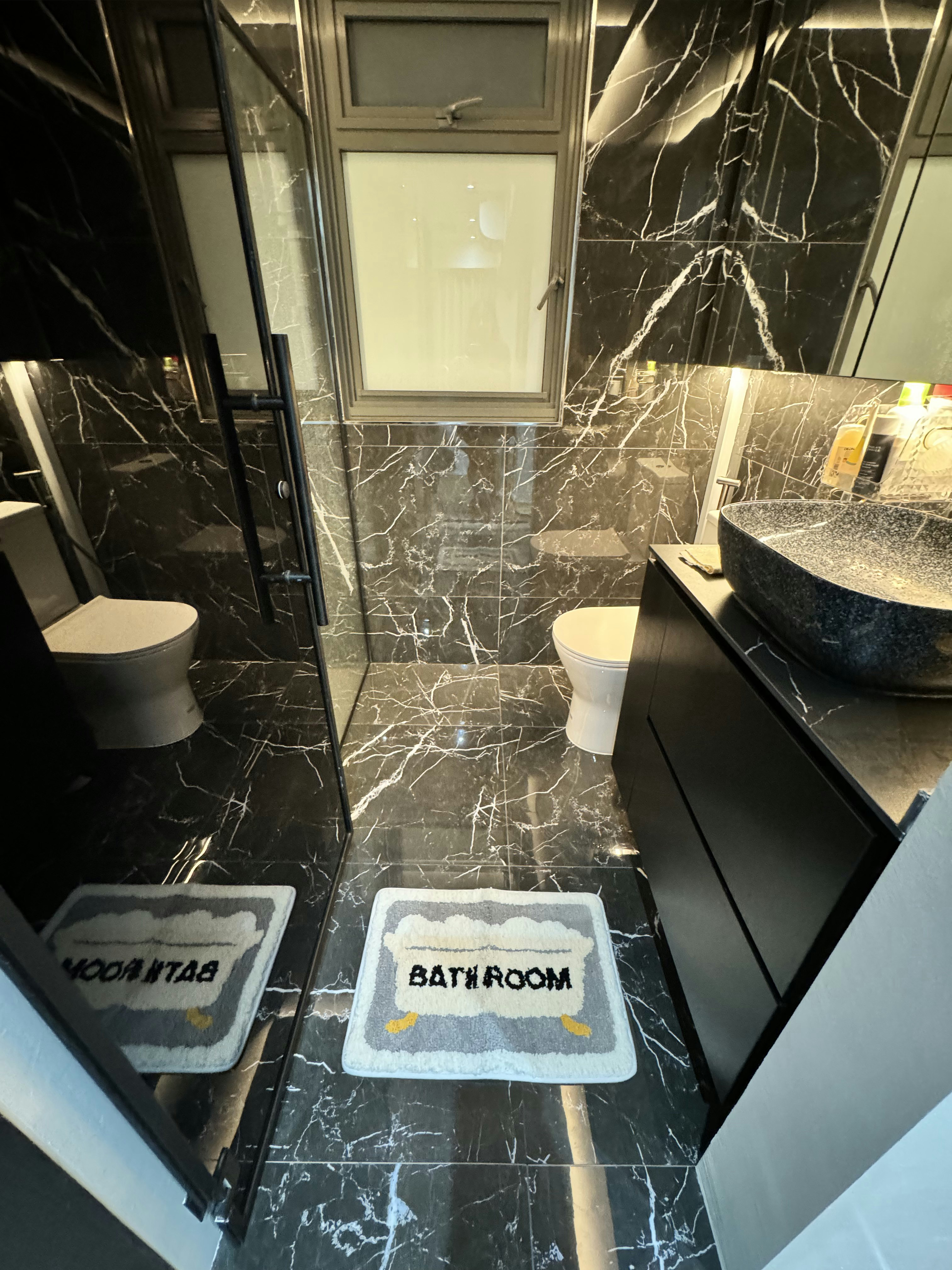 Cozy vibe with modern victorian style - Modern bathroom with black marble tiles, sleek black cabinets, large vanity sink, two