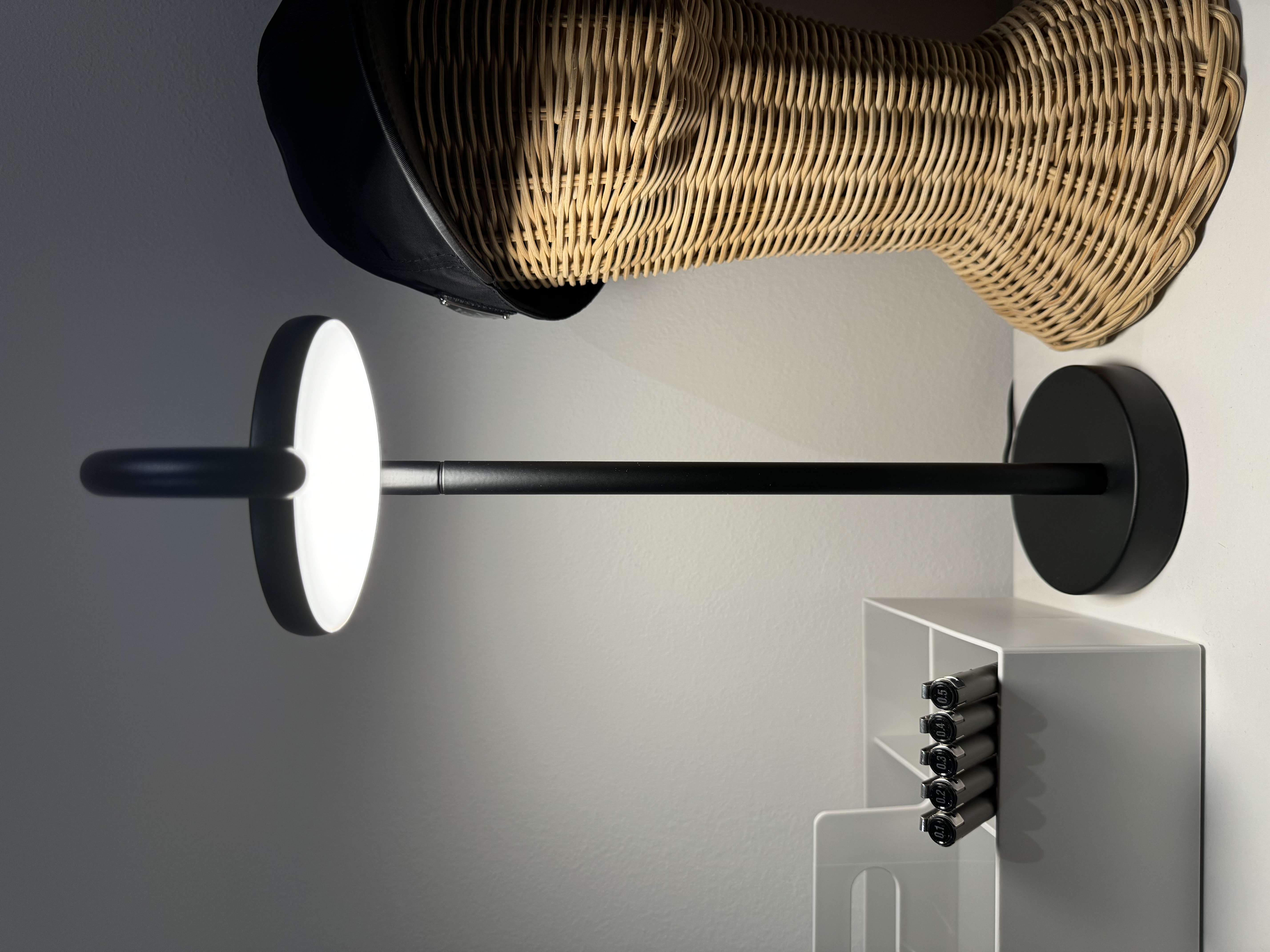 Study @ Rumah Beacon - Modern minimalist design, sleek black wall sconce, circular light fixture, white wall background