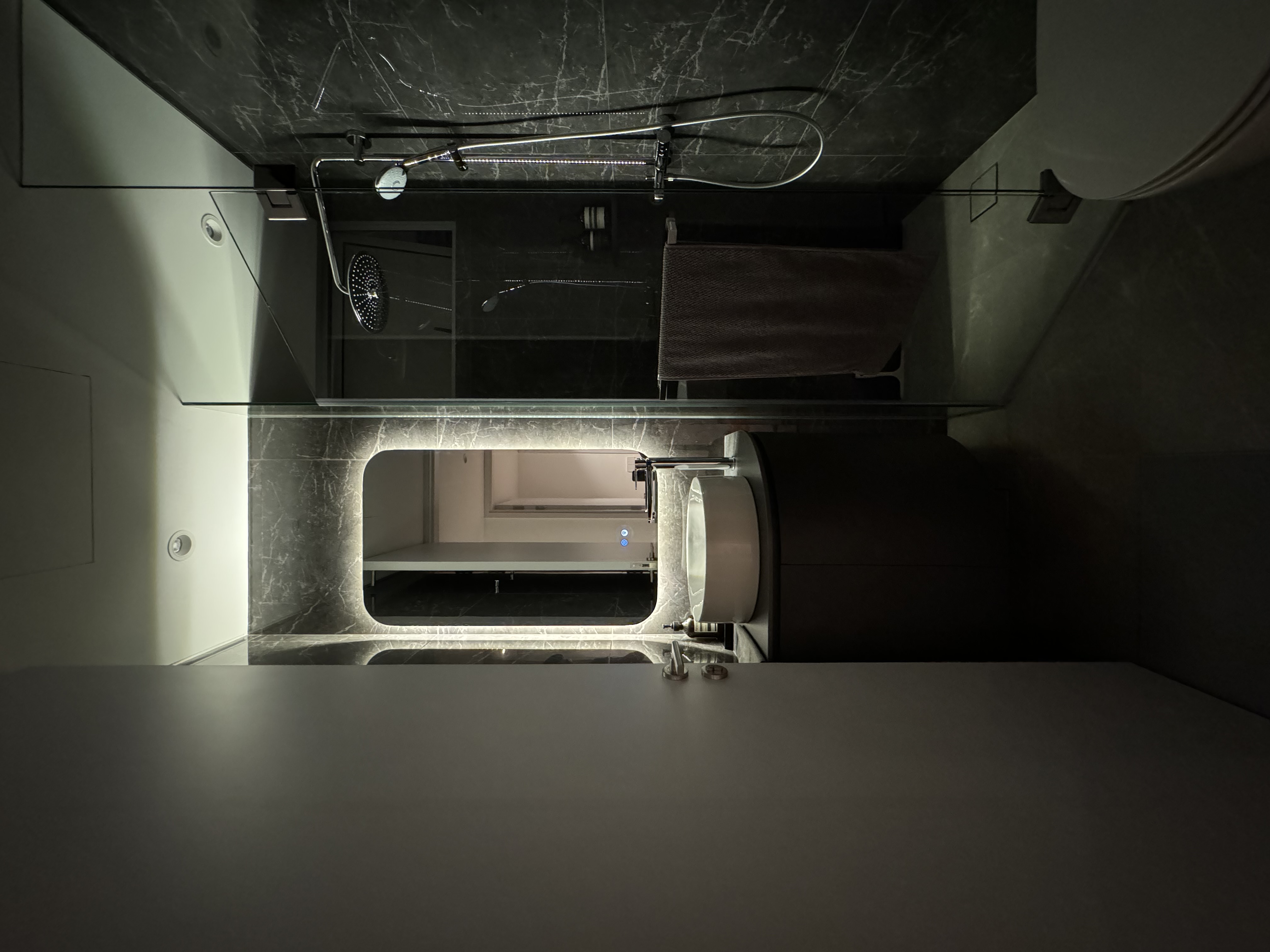 Let There Be Light! - Modern minimalist bathroom, sleek design, dark marble walls, contemporary fixtures, under-cabinet