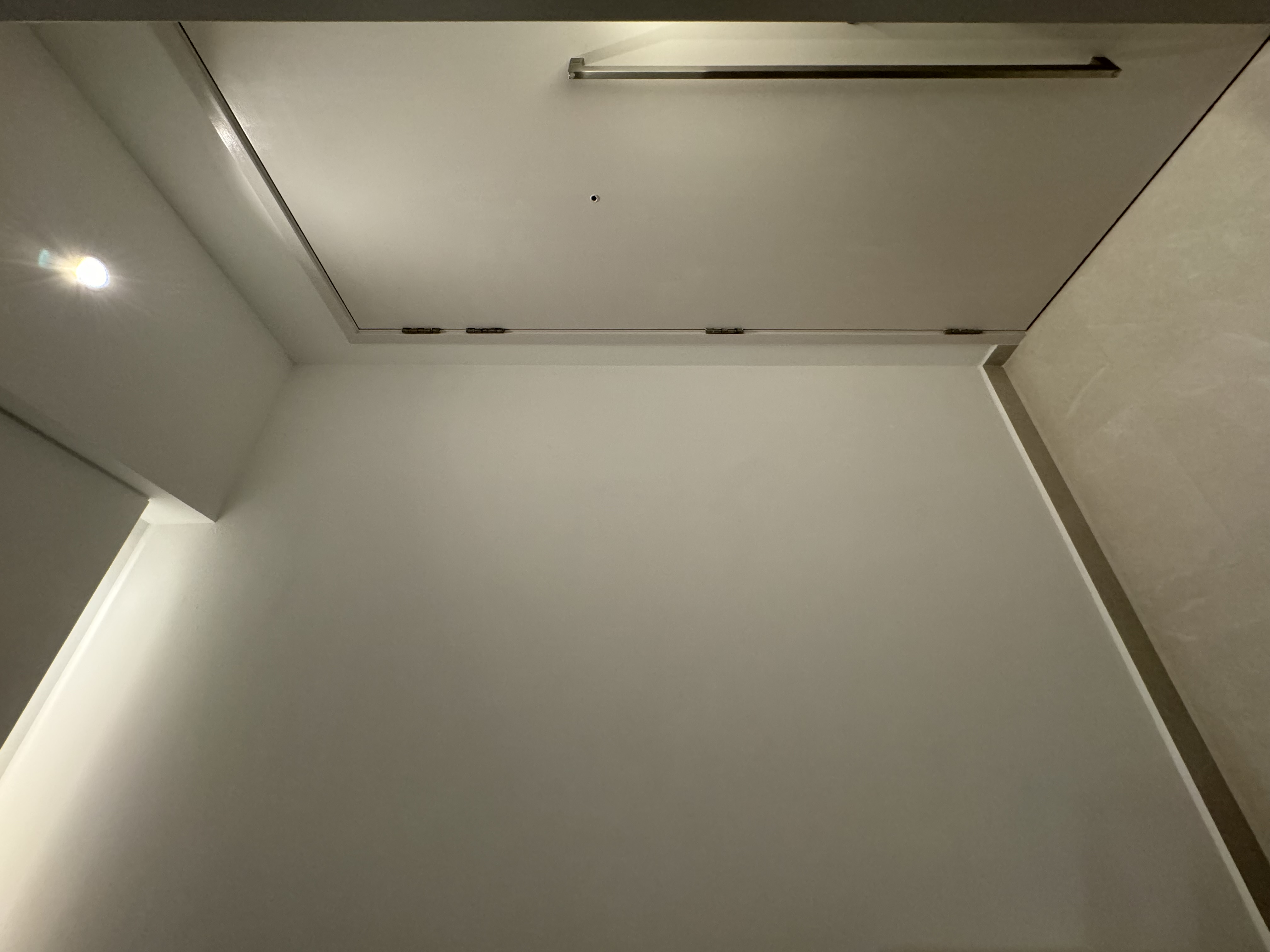 Enter Into Rumah Beacon - Modern minimalist bathroom, sleek ceiling light, clean white walls, recessed lighting, corner