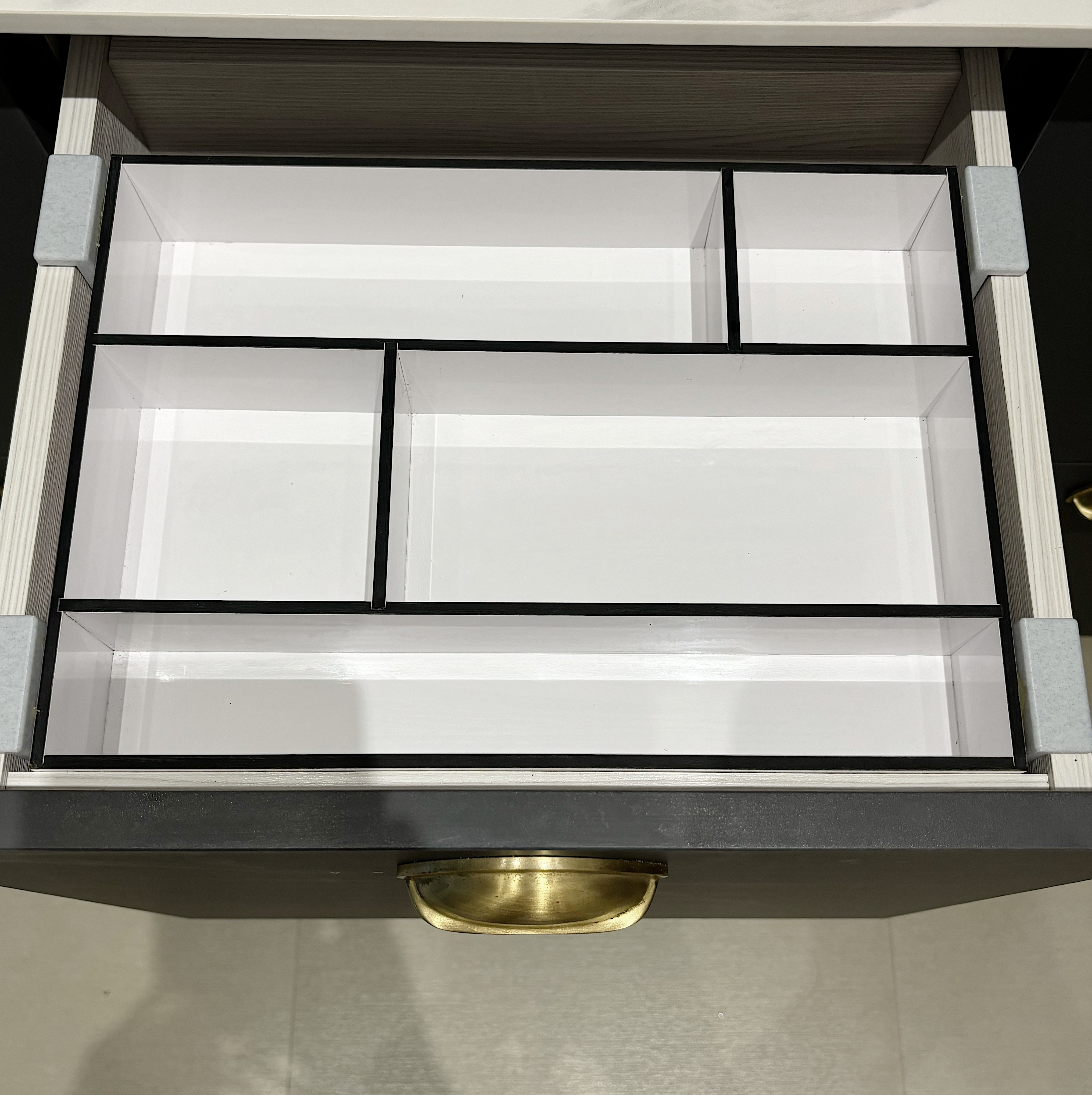 Home organization hacks for a more efficient home! - Shelf with empty compartments, minimalist design, black and white color