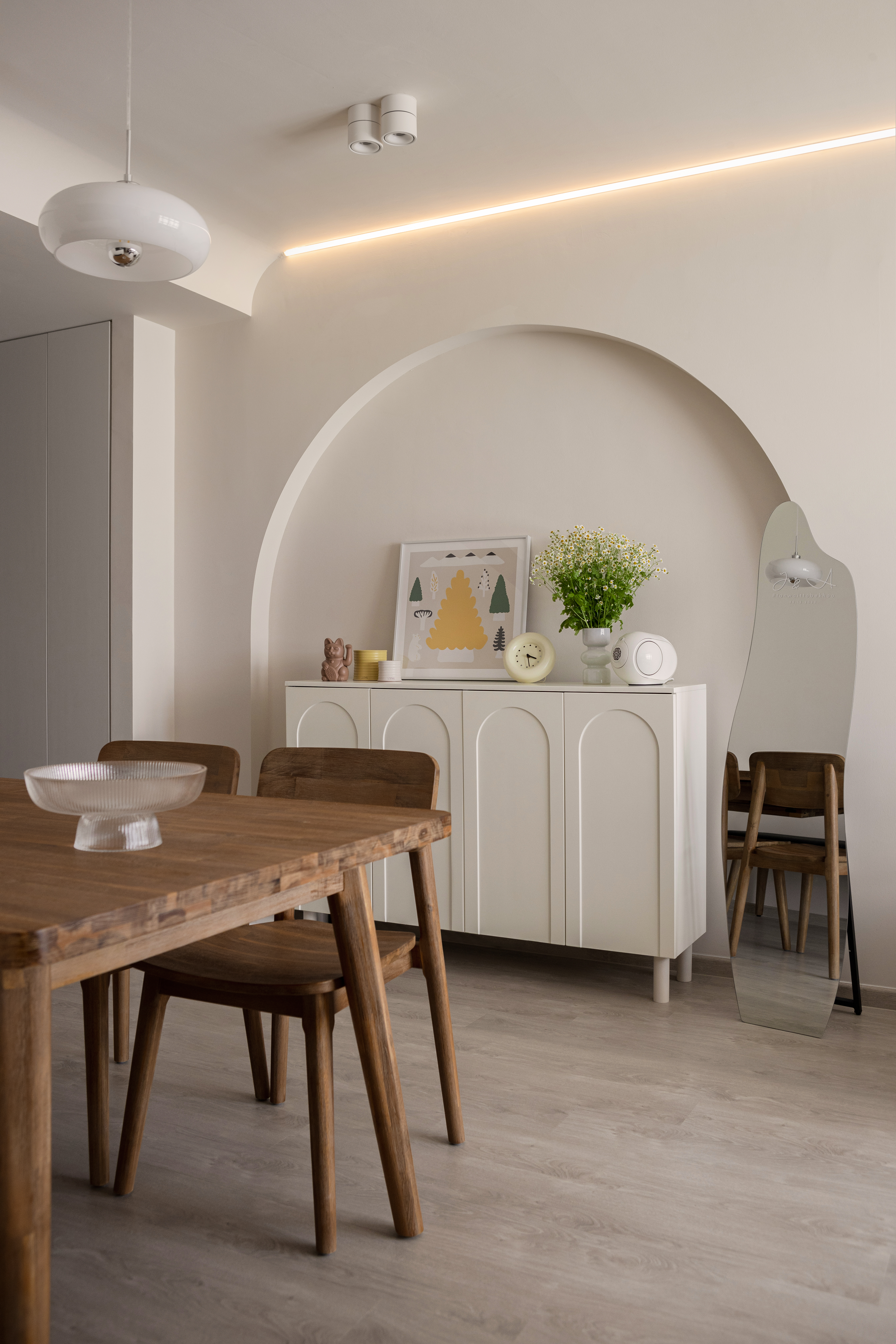 Cozy and creamy living space with a warm inviting ambience - Modern minimalist dining room, sleek pendant light, arched
