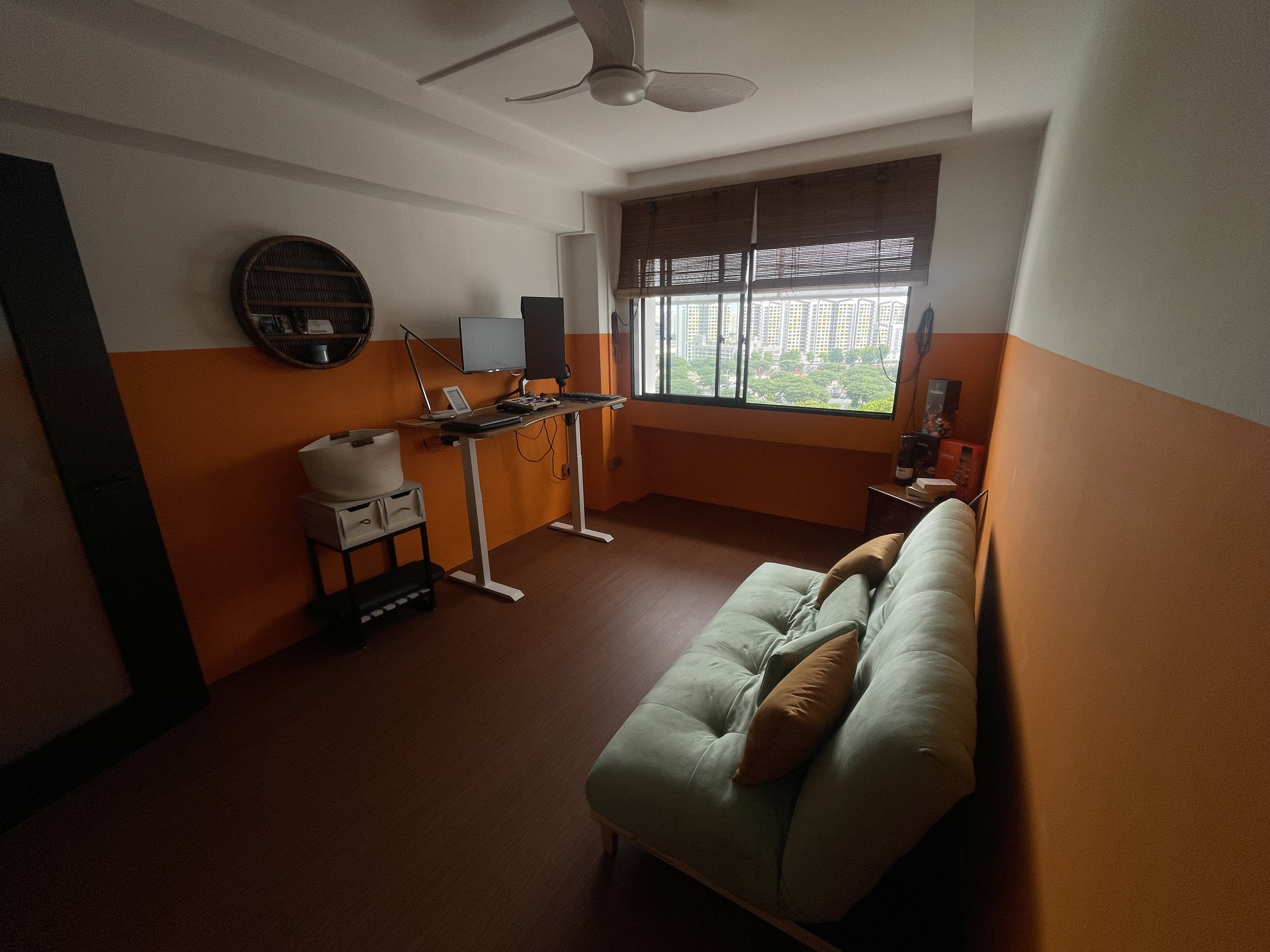 A unique blend of mid-century charm & cottage coziness - Orange and white walls, modern desk, computer setup, comfortable