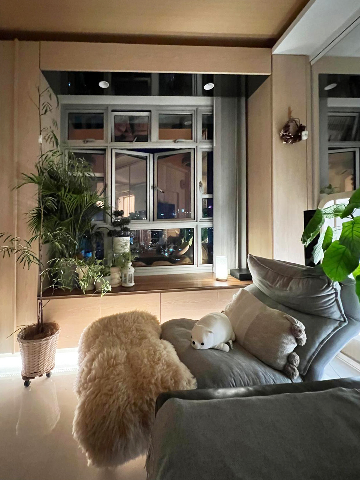 "Embracing the Magic: Day and Night Views from Our Nest ✨🌙" - Lush green plants, cozy seating area, soft beige rug, plush