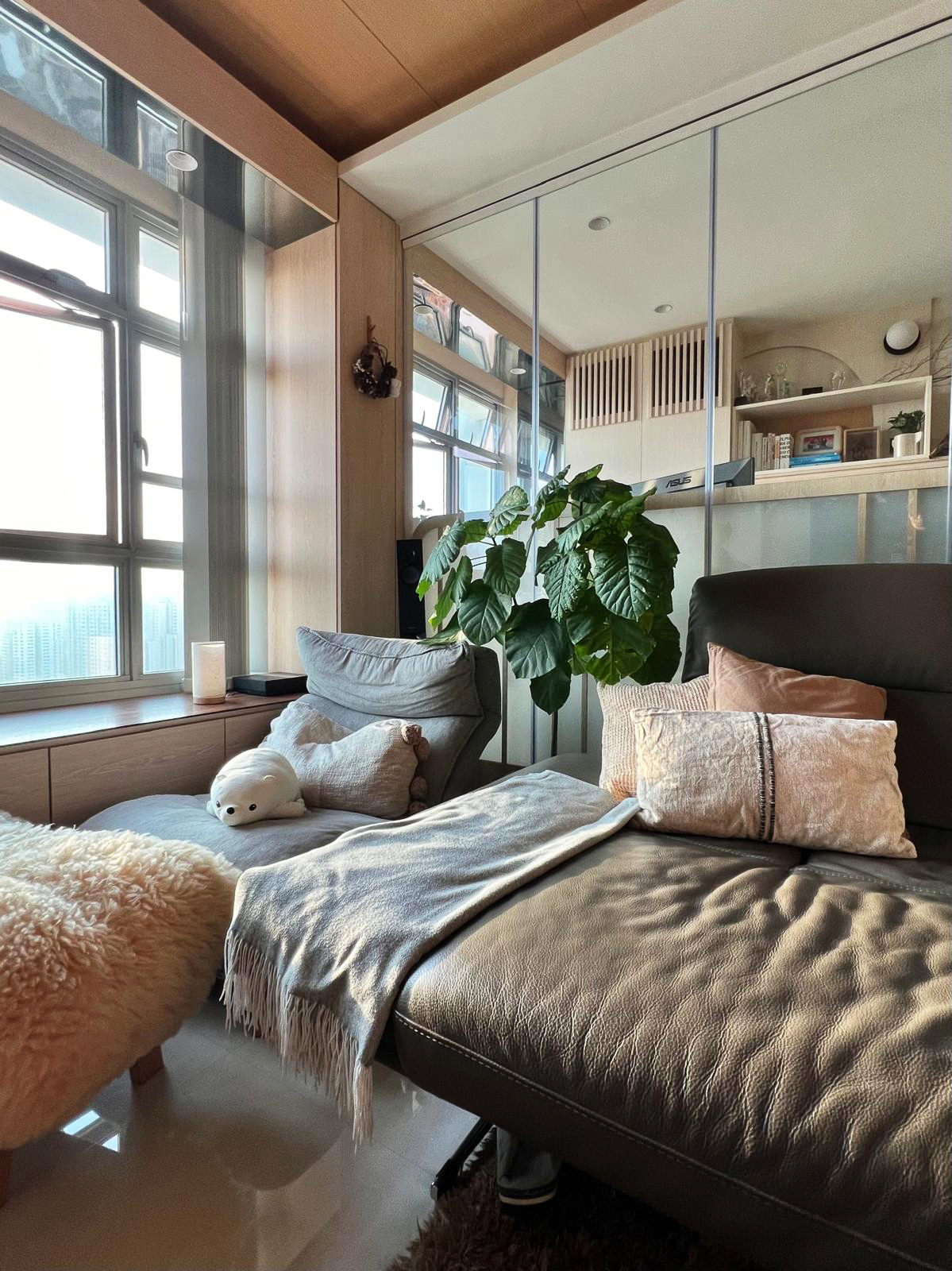 "Embracing the Magic: Day and Night Views from Our Nest ✨🌙" - Wooden window frame, large green plant, cozy sofa, plush beige