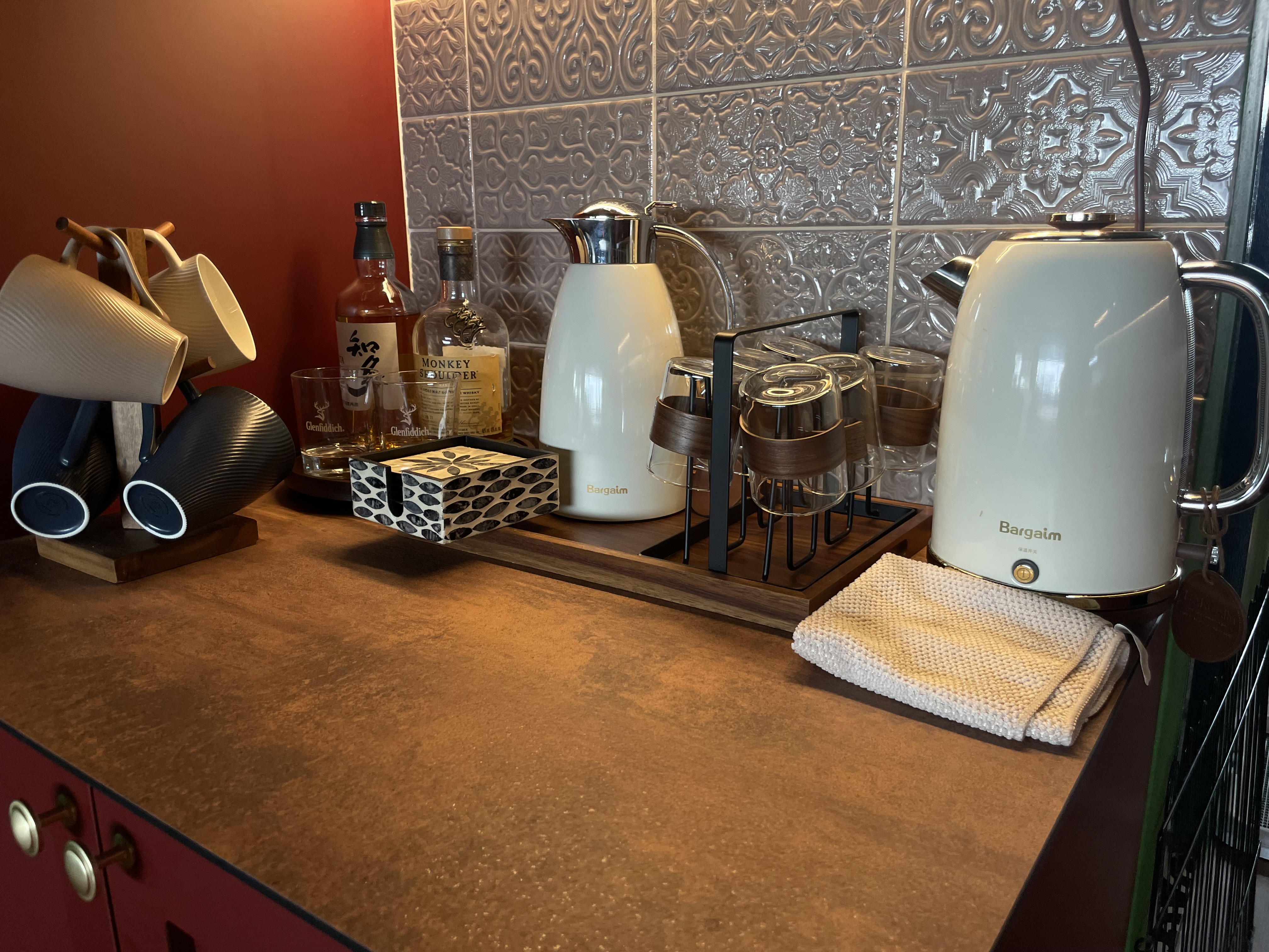 A unique blend of mid-century charm & cottage coziness - vintage kitchen countertop, elegant tea set, wooden utensils