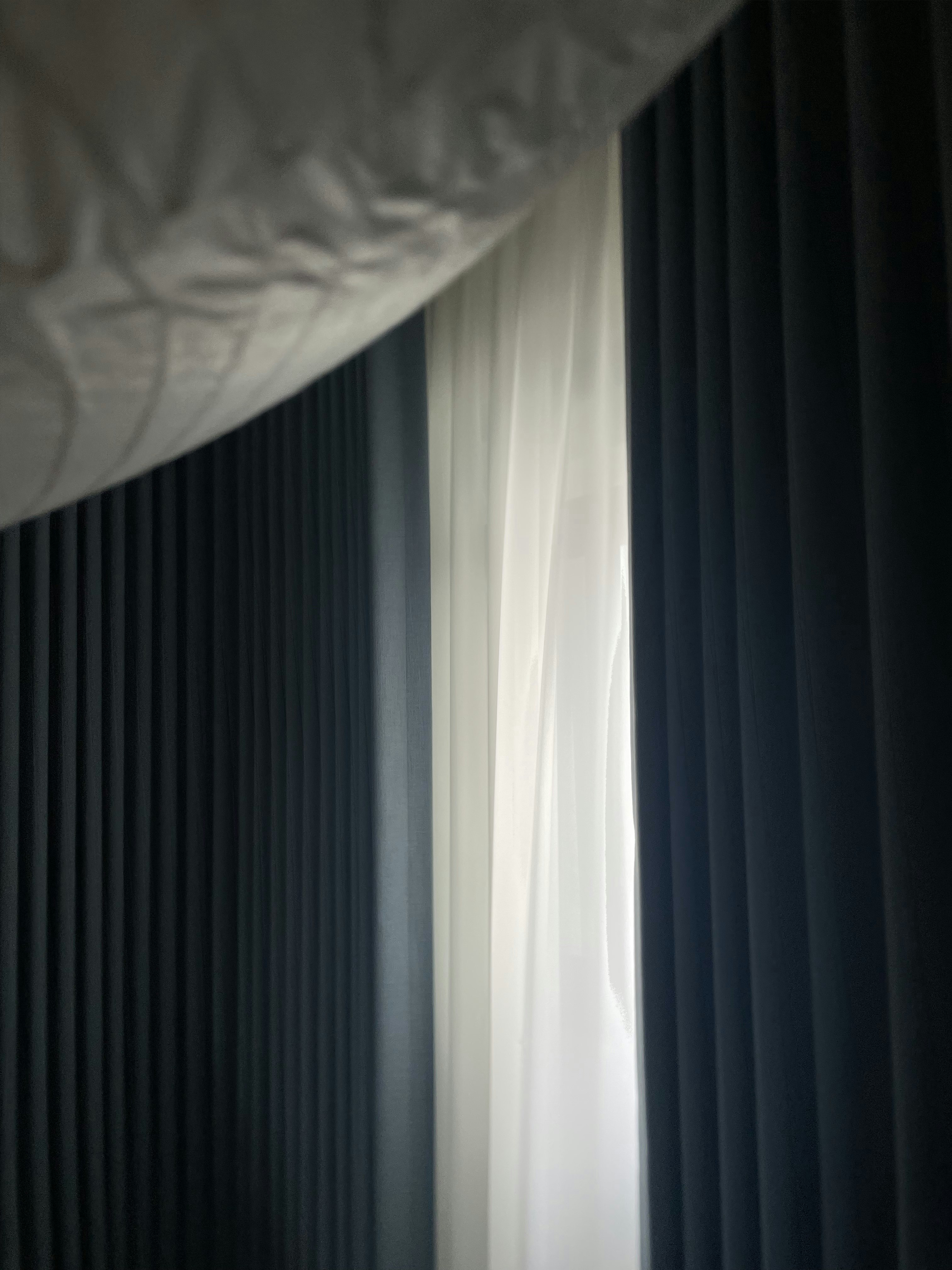 reviving resale HDB corridor unit with mid-mod twist! - Dark curtains, sheer white curtain, natural light filtering, vertical