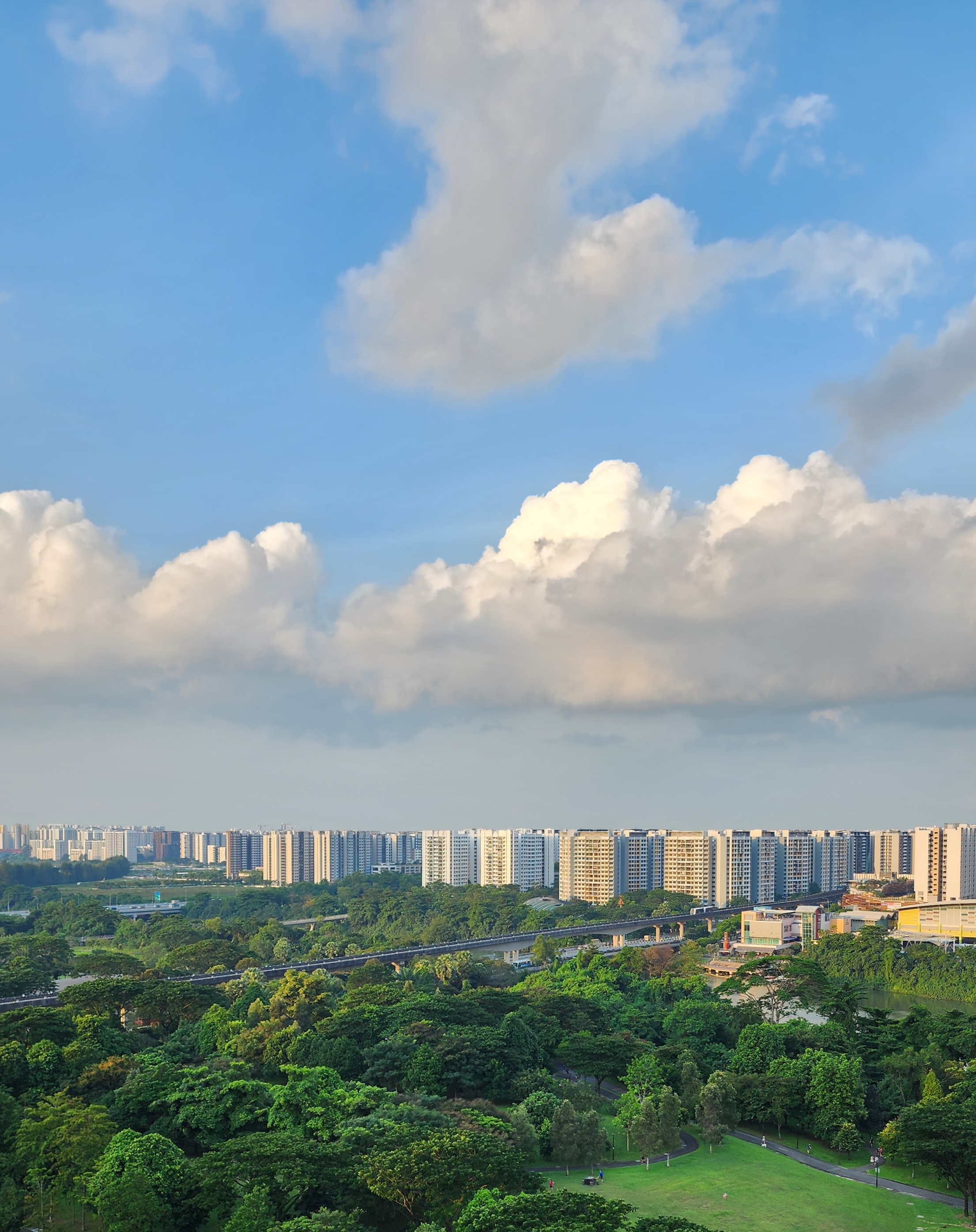 Functional or Aesthetics? Our $100K Modern Minimalist 4Room HDB! - Urban skyline with tall apartment buildings under a blue