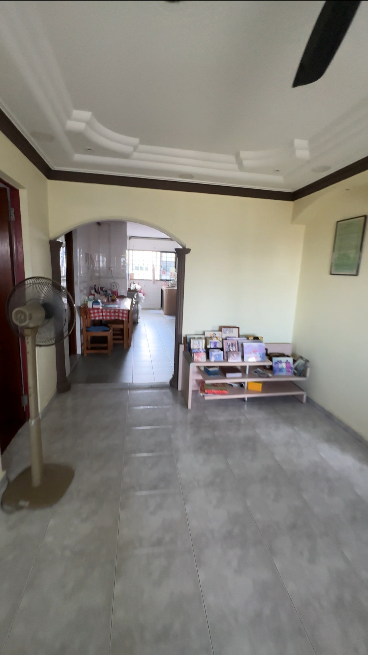 Welcome to our newly renovated 30 ish year old HDB jumbo! - Interior view of a room with tiled floor, ceiling fan, wooden