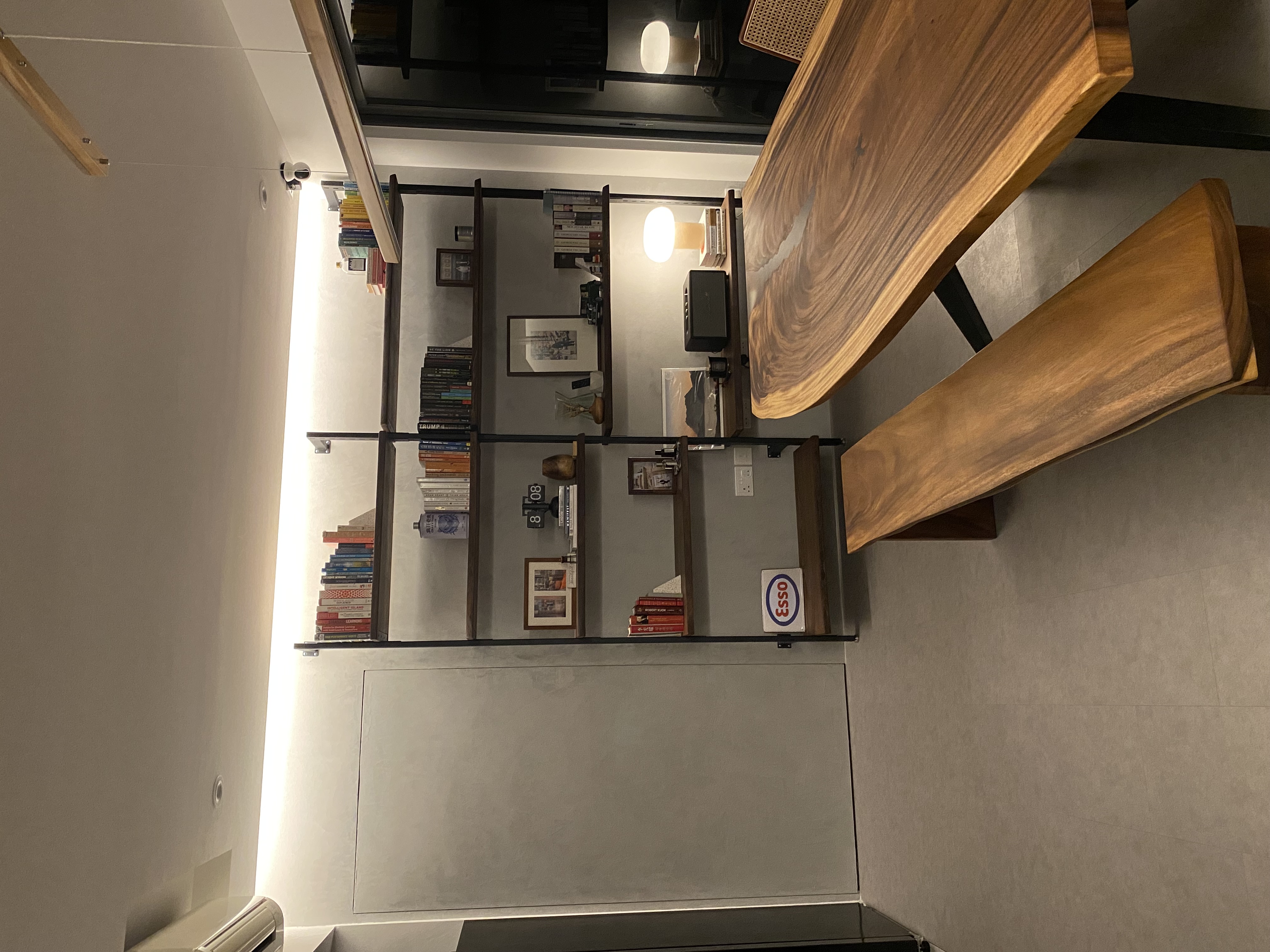 A-home-gallery-and-library-in-dark-wood-and-grey-tones