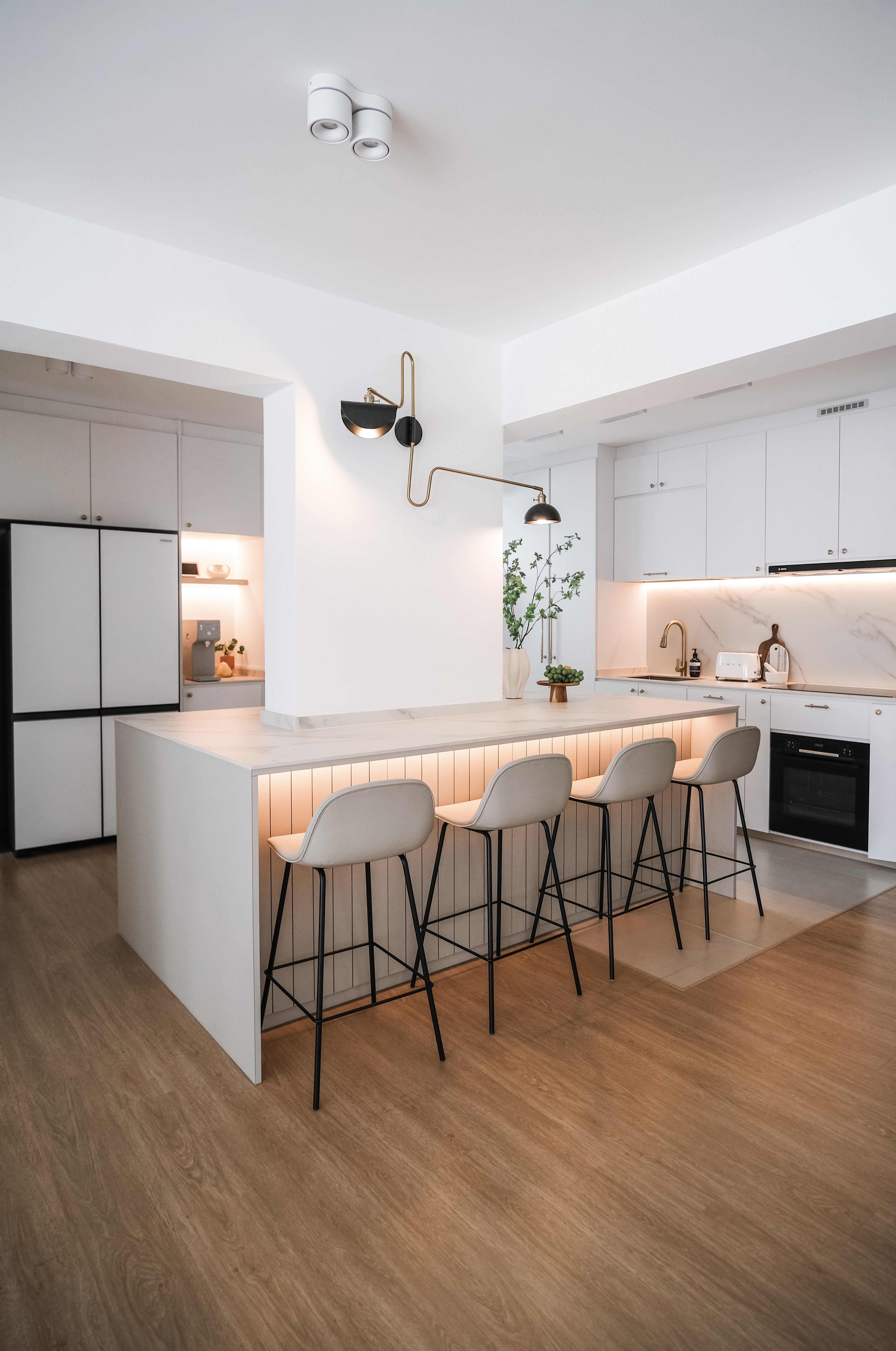Modern Home With A Large Kitchen Island Around A Pillar. - Modern kitchen with sleek white cabinetry, minimalist design, open