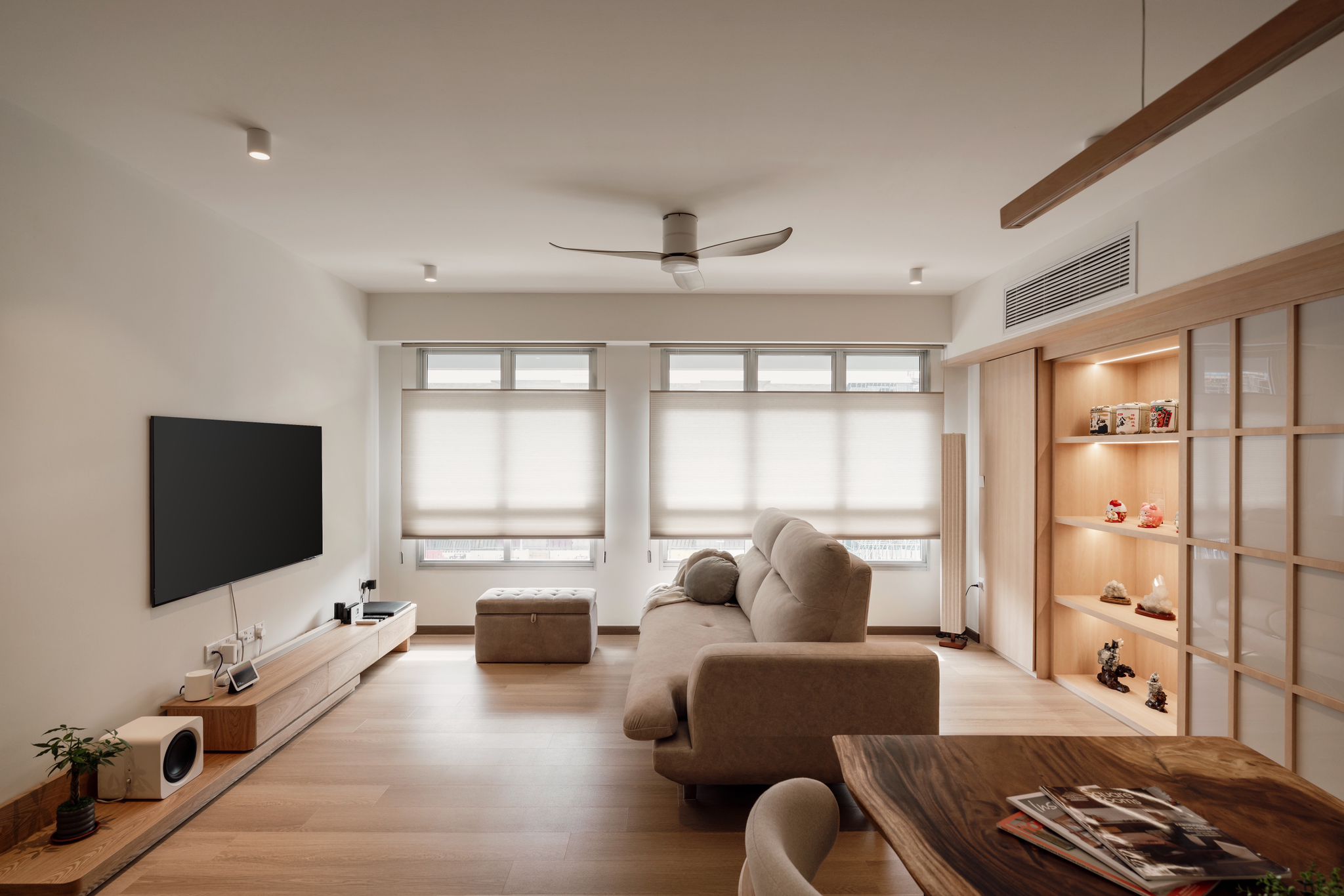 Inside our 5room Japanese inspired home - Modern living room with large flat-screen TV, wooden floor, beige sofa, built-in