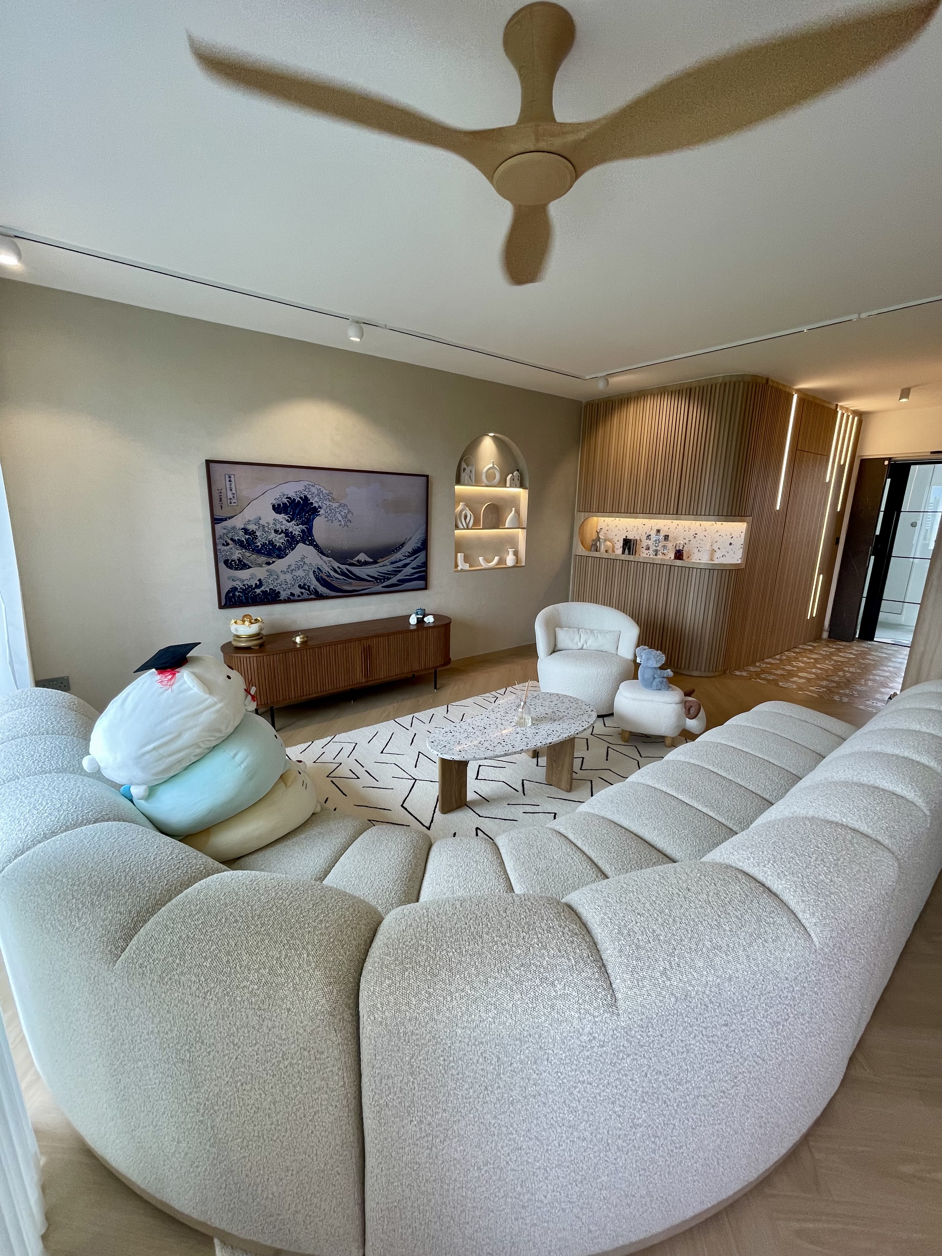 A Self-designed Cosy Abode at Woodleigh Hillside - Modern living room with plush beige sectional sofa, abstract patterned